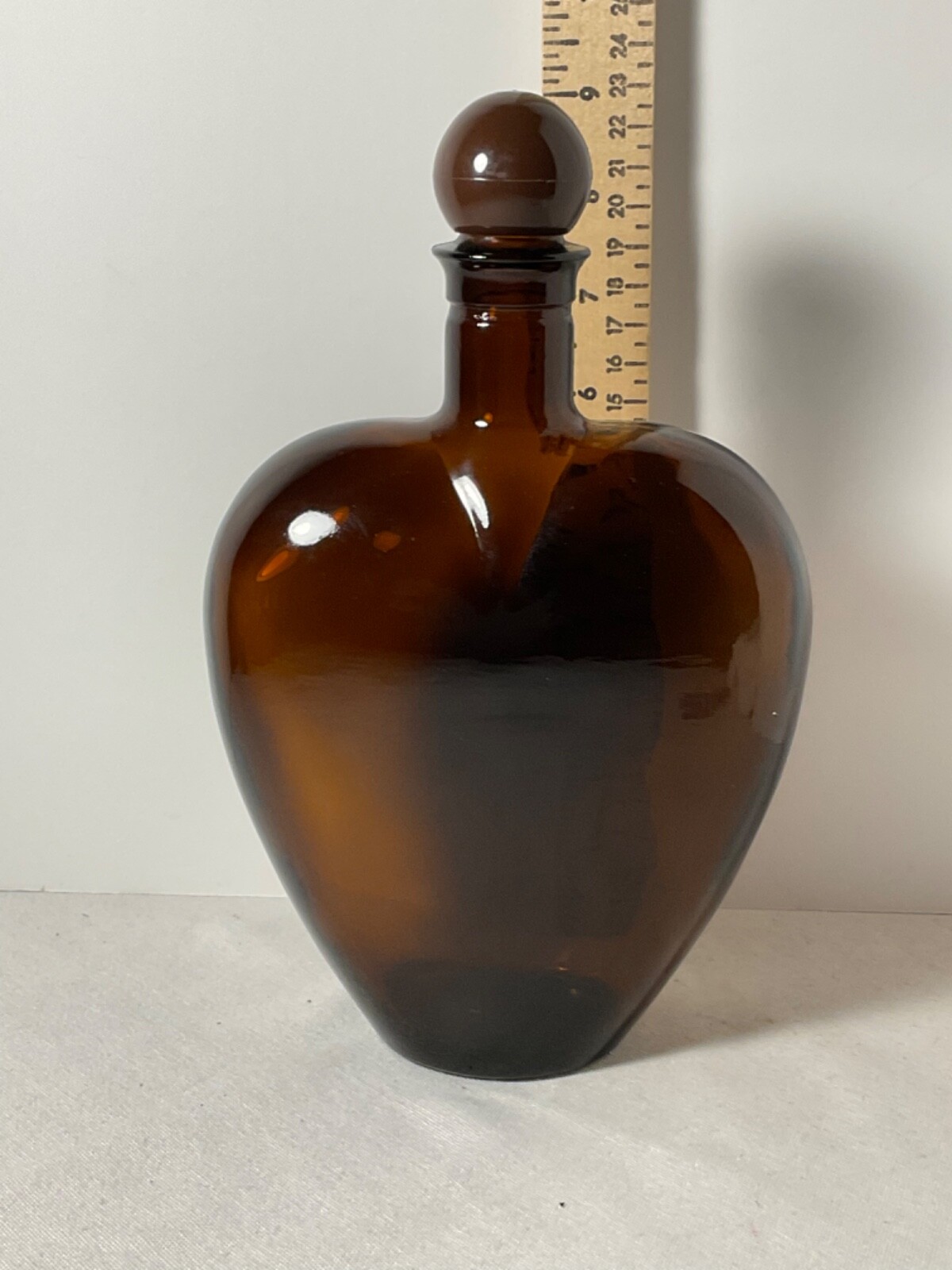 Brown glass heart shaped bottle plastic cap 9”