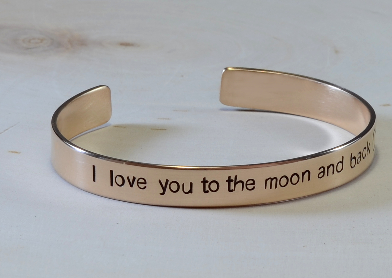 bronze cuff bracelet with i love you to the moon and back