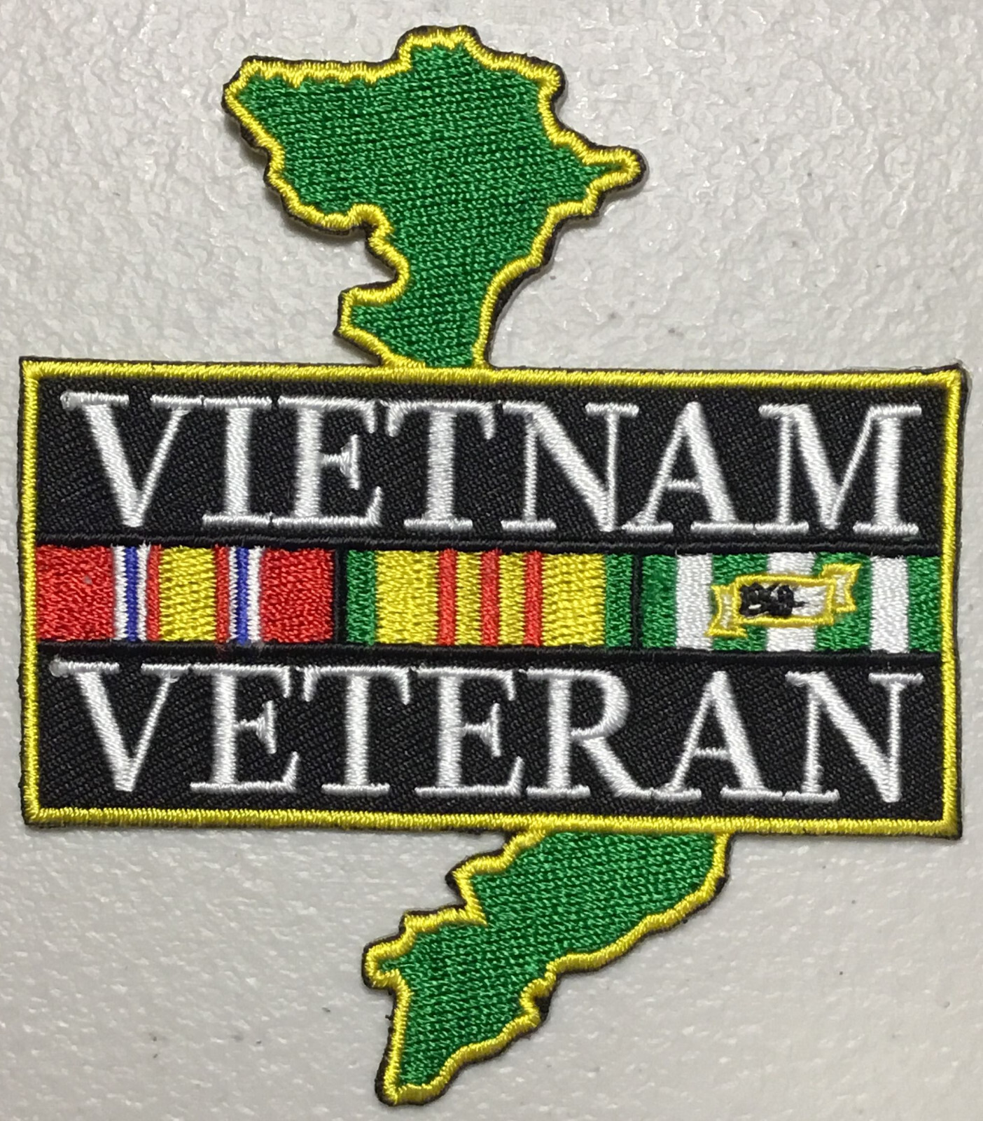 Vietnam Service Veteran with ribbons overlaying map of Vietnam patch
