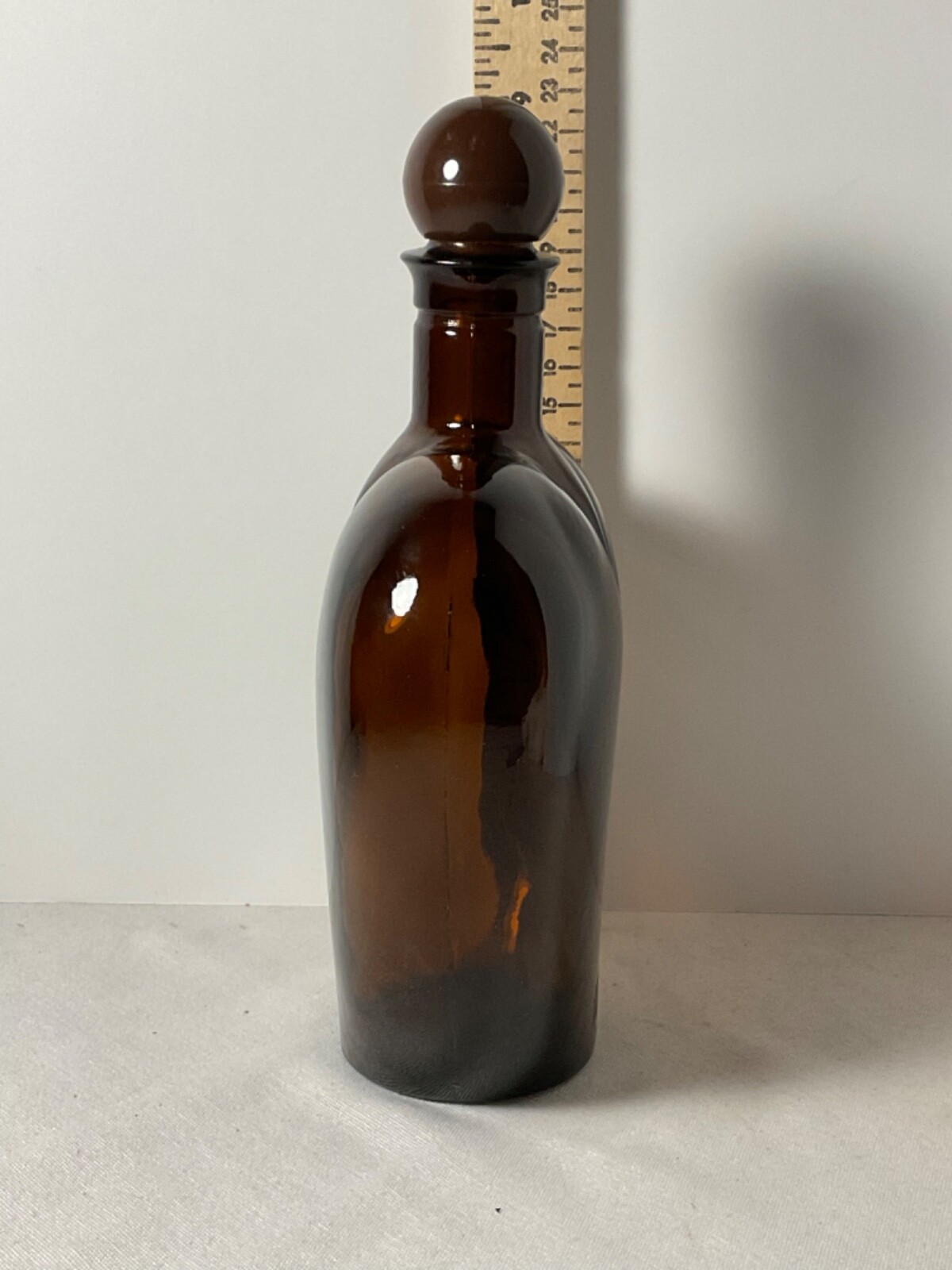 Brown glass heart shaped bottle plastic cap 9”