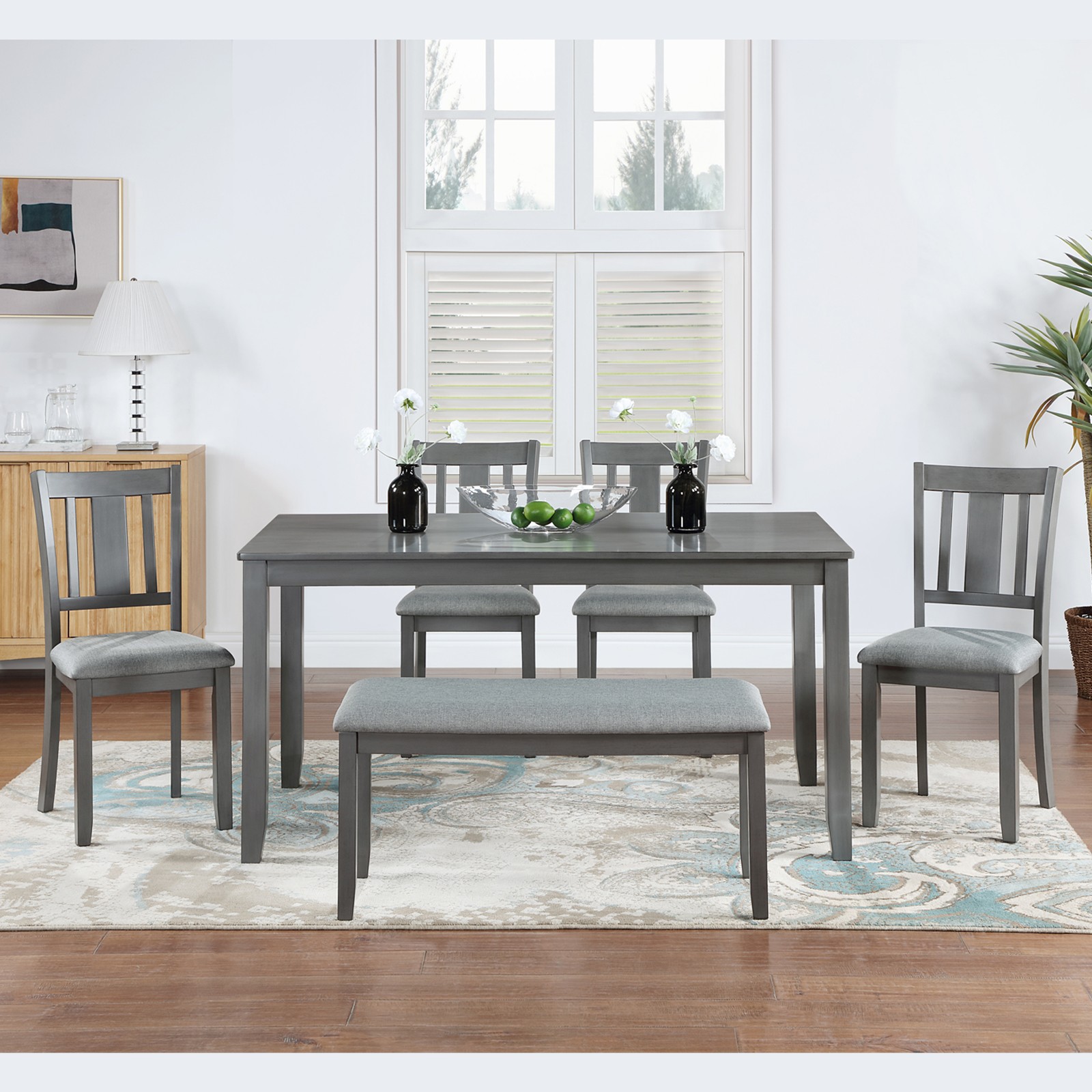 A rectangular dining table, equipped with 4 upholstered chairs and a long bench