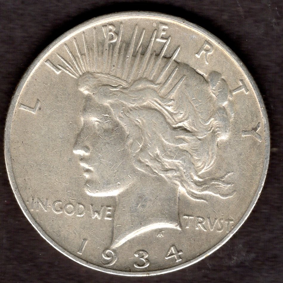 1934-D PEACE SILVER DOLLAR.  ABOUT UNCIRCULATED.  YOU GRADE IT.