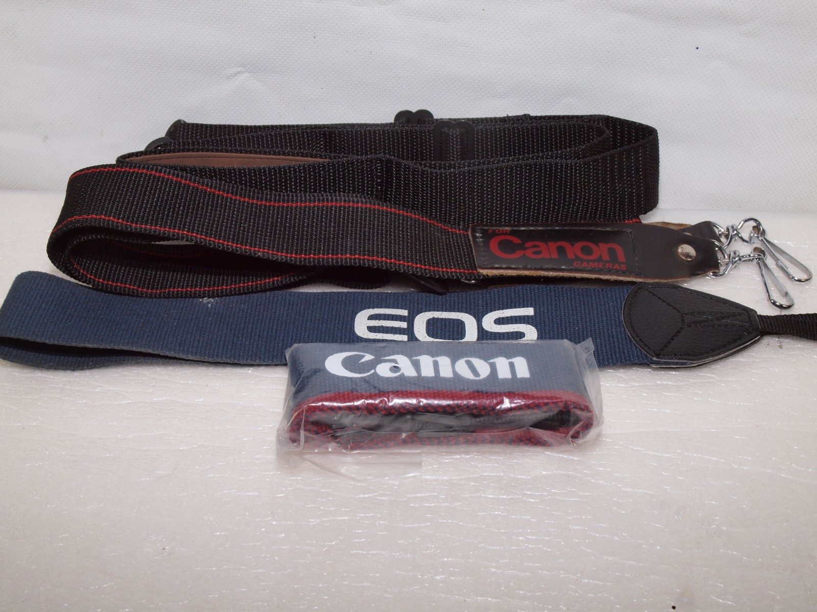 Canon camera straps- 1 new in package includes Canon EOS wide strap.