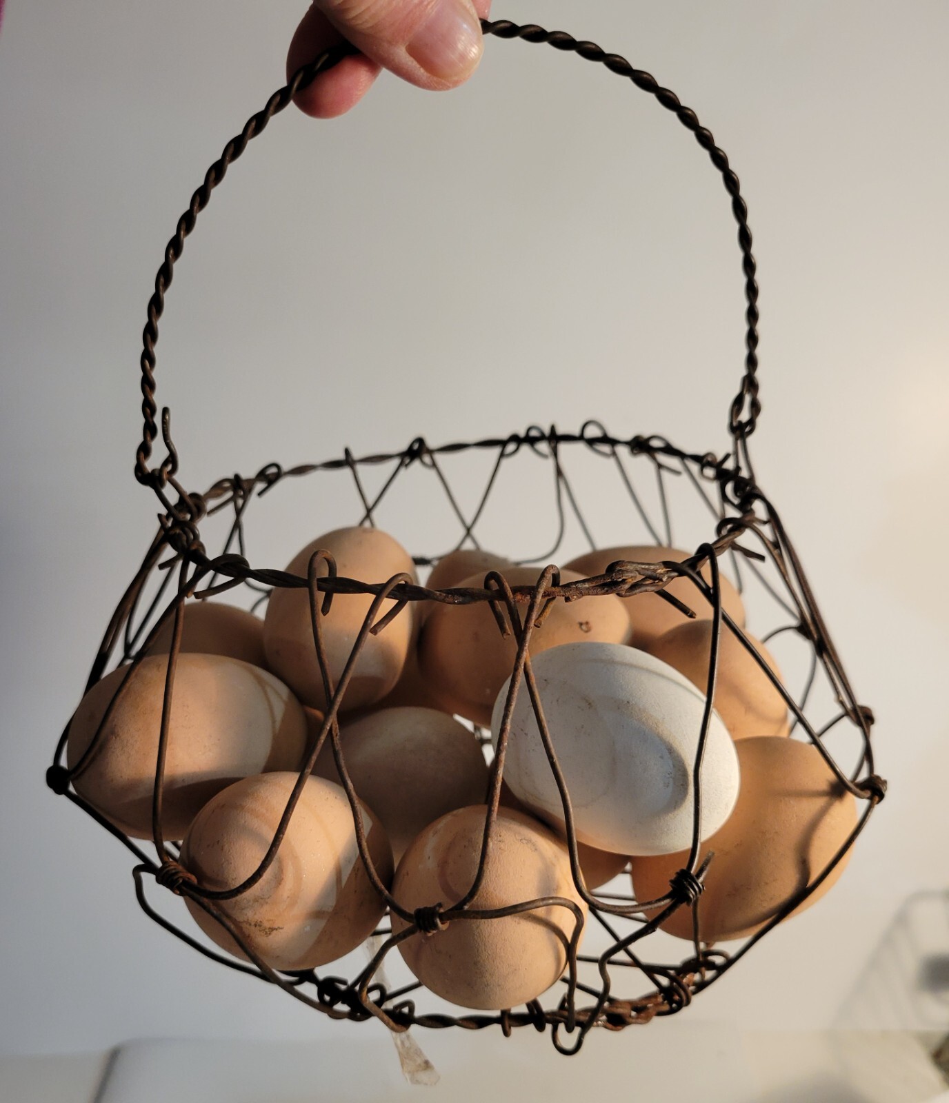 Wire Egg Basket Collapsible filled with 14 wooden eggs