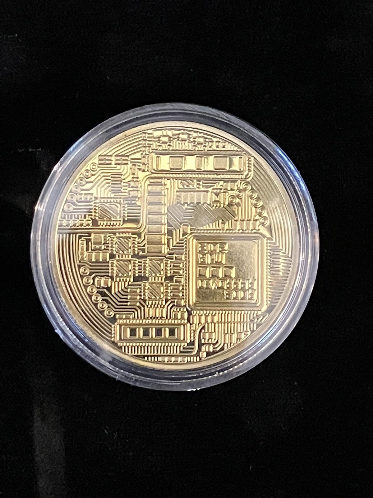 Bitcoin - gold colored Bitcoin in protective case.