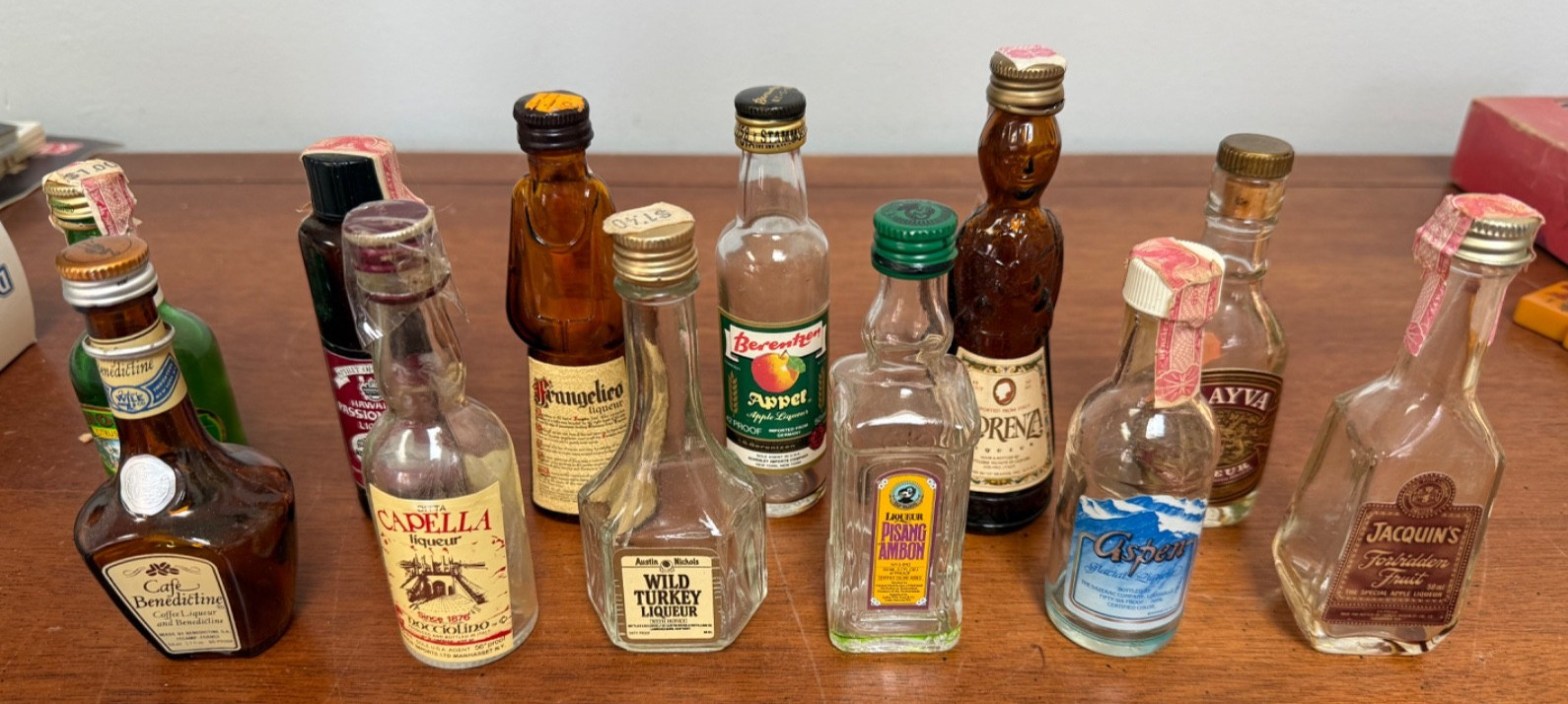 12 Miniature Liqueur Bottles, Empty, With Lids, Some torn Tax Stamps