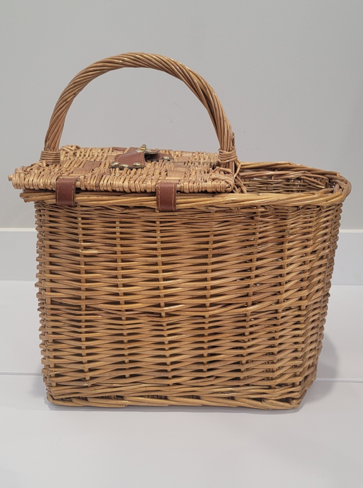 Vintage woven rattan or wicker picnic basket, the 1970s with citrus-print fabric