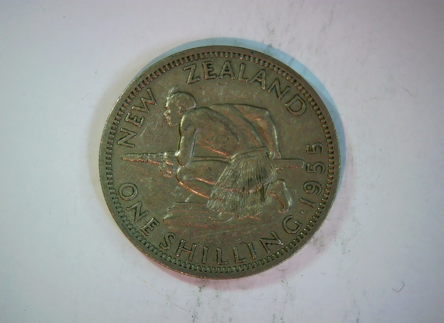 New Zealand 1955 1 Shilling Elizabeth II (young head) / Maori warrior (Te Raupar