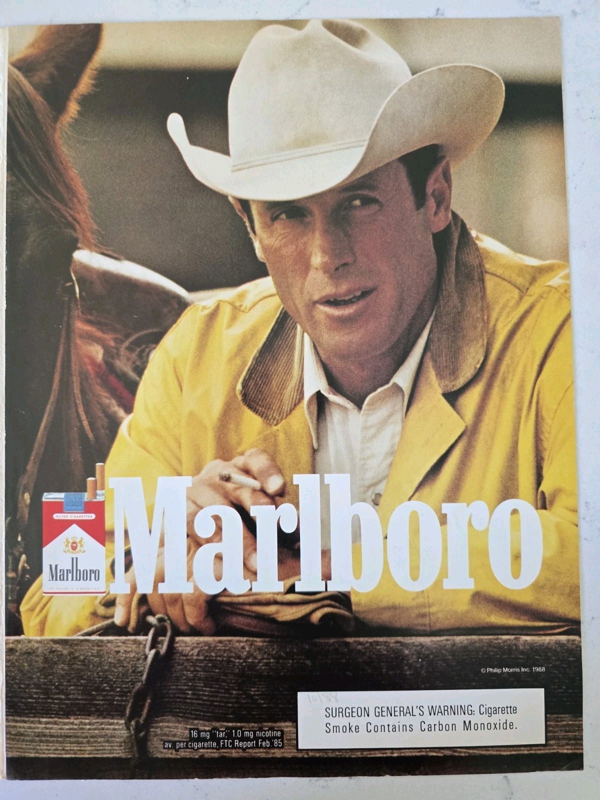 1988 Marlboro Cigarettes Cowboy Smoking yellow jacket hat vintage Ad