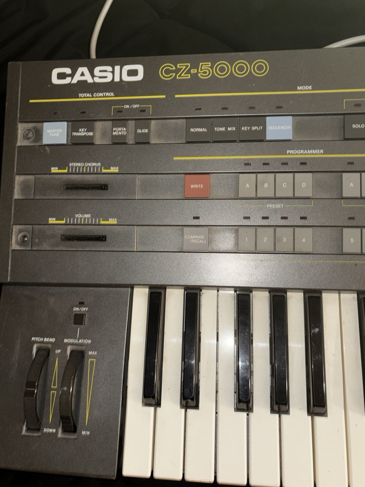 Casio CZ-5000 comes with power cable and stand
