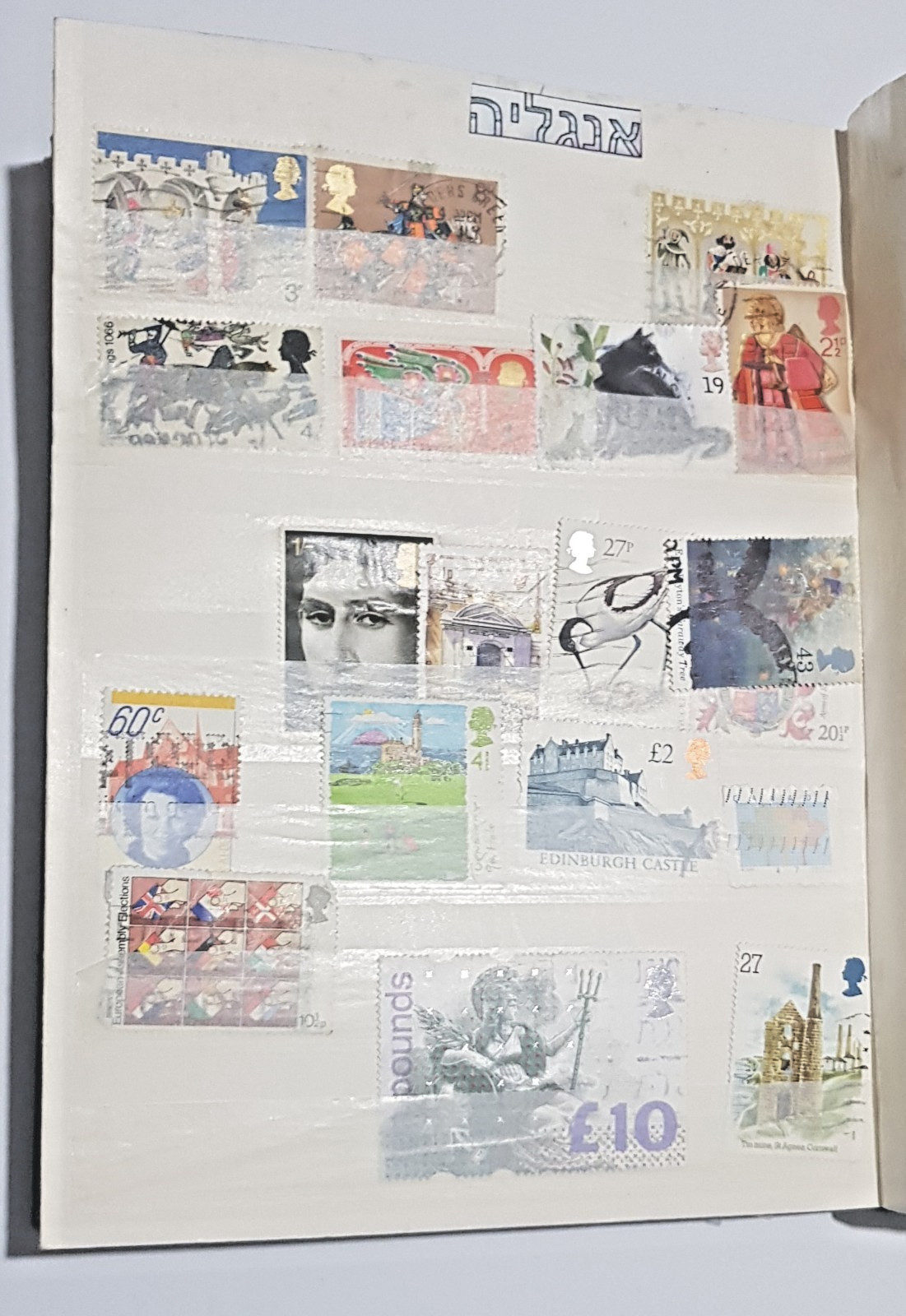 Collection of ~600 international stamps  some w/ Tabs in well used stock book