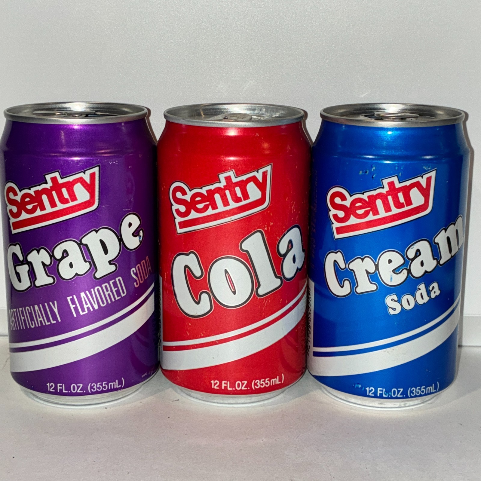 lot of 3 Sentry soda cans, grape, cola, cream soda