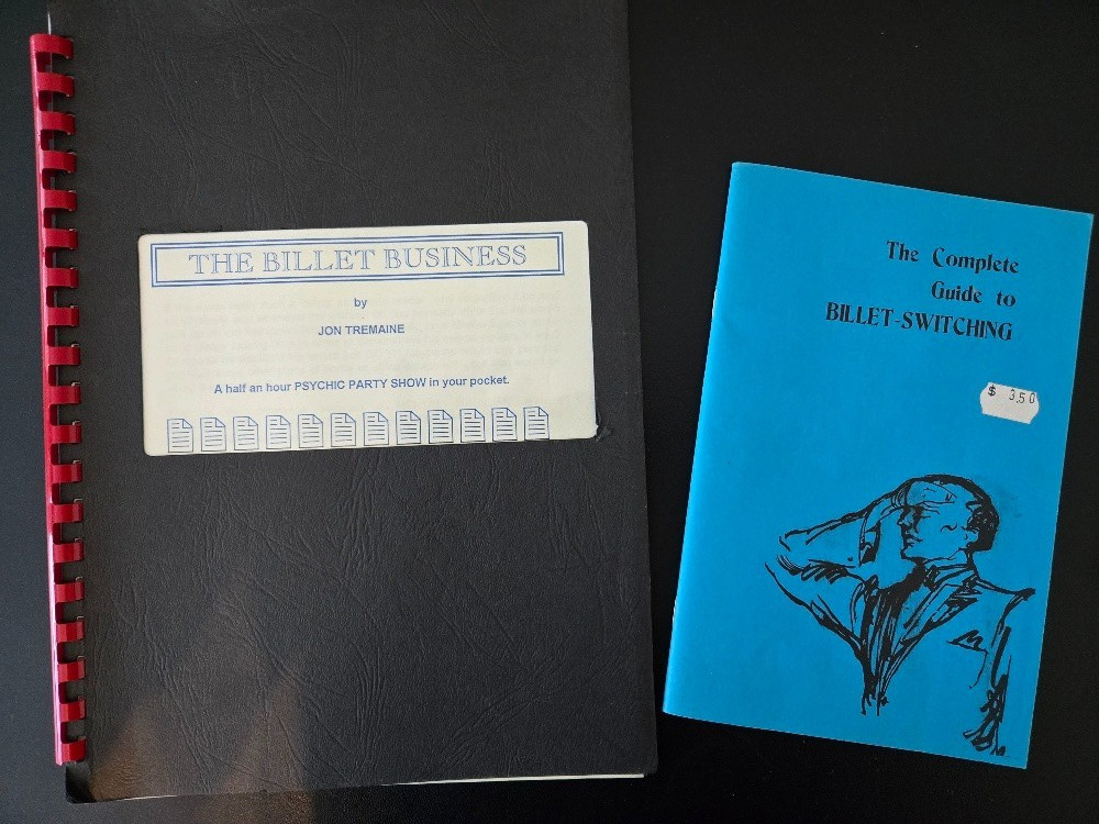 Two books on mentalism with billets