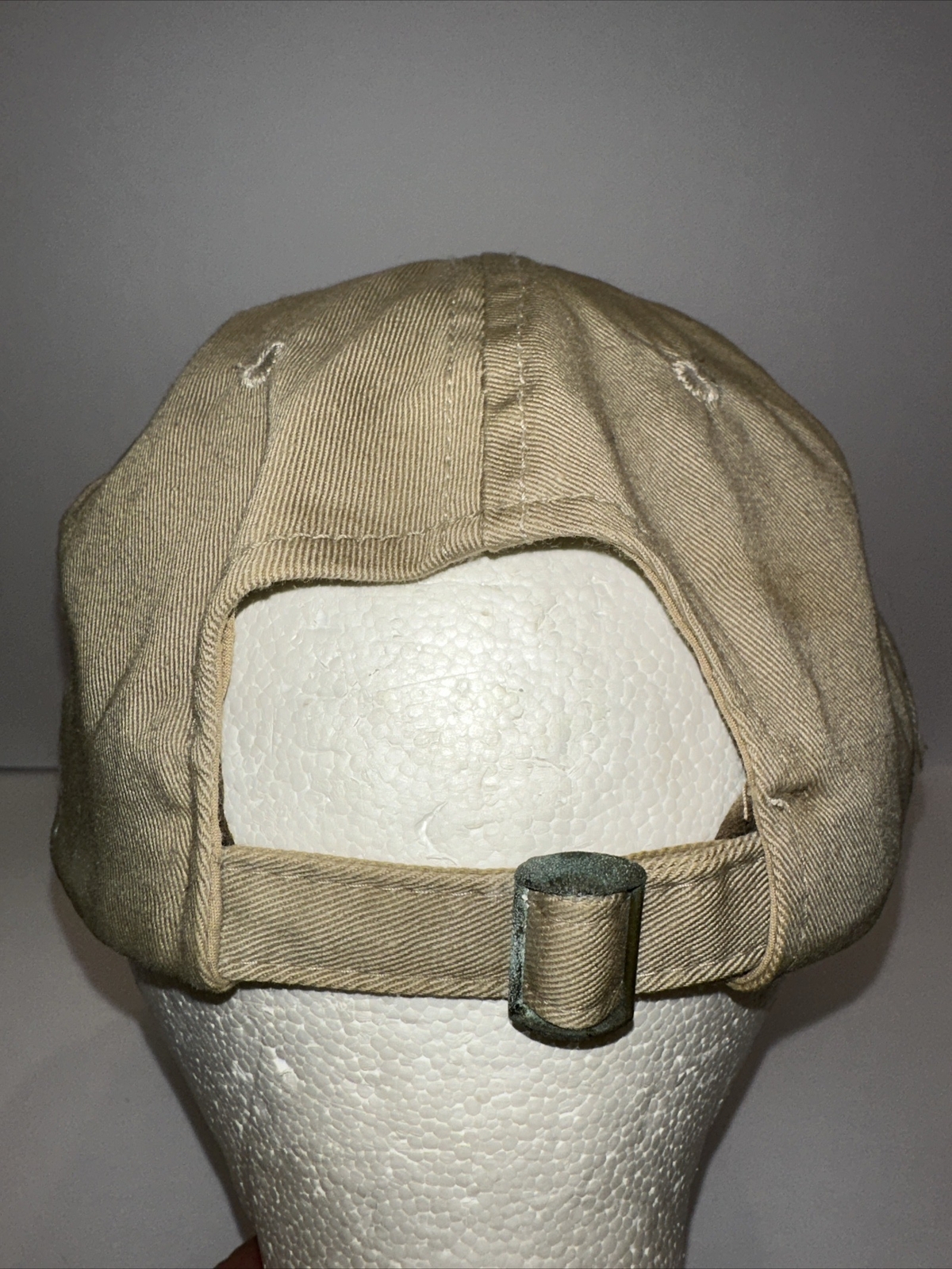 Bushmasters Logo Patch on Tan Hat Cap with Camouflage Edge on Bill Strap Buckle