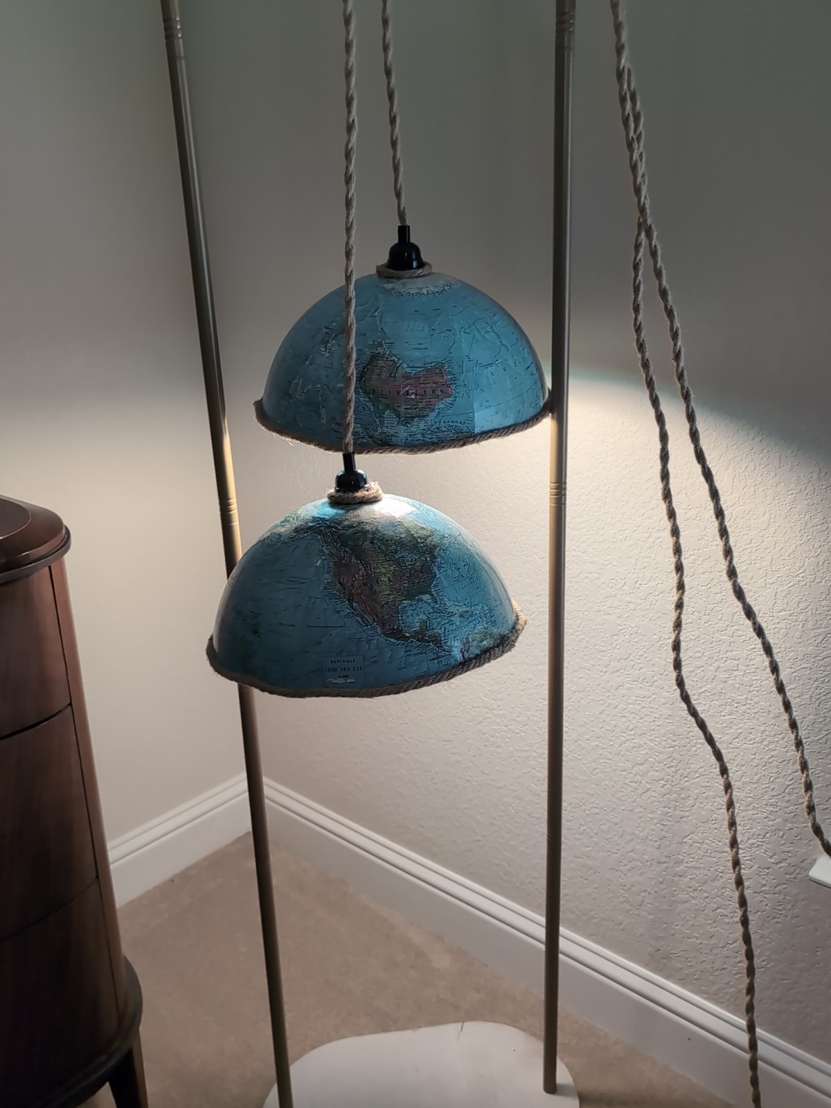 upcycled world globe pendant light fixture featuring two halves vintage globe