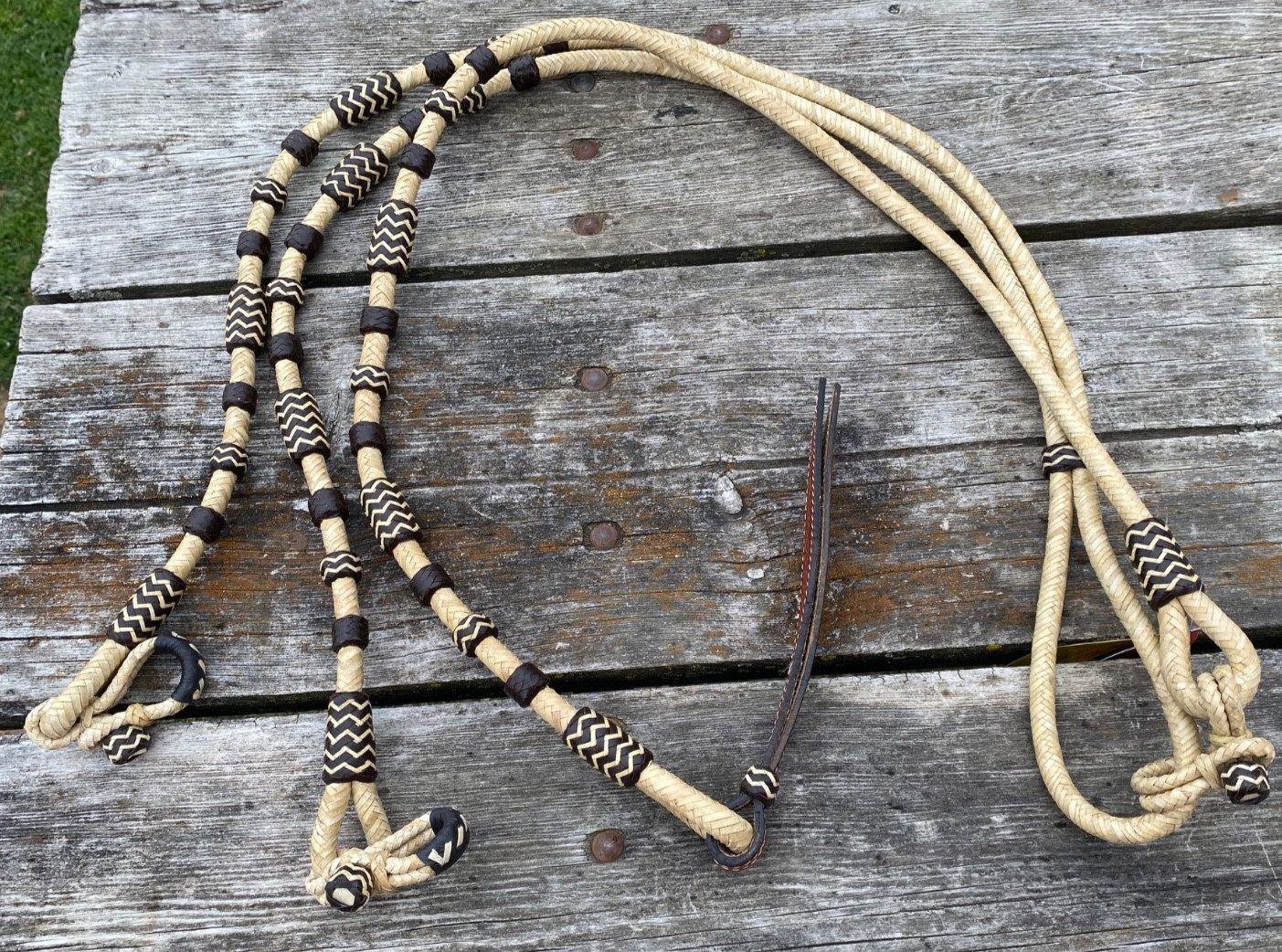 Braided rawhide Romel/Romal reins w/dark brown accents & leather popper