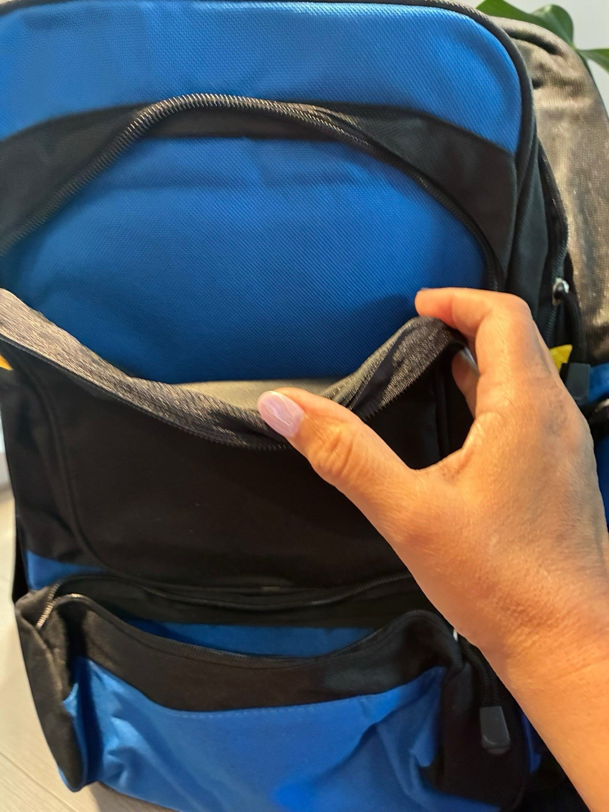 Black And Blue Backpack With Many Pockets.