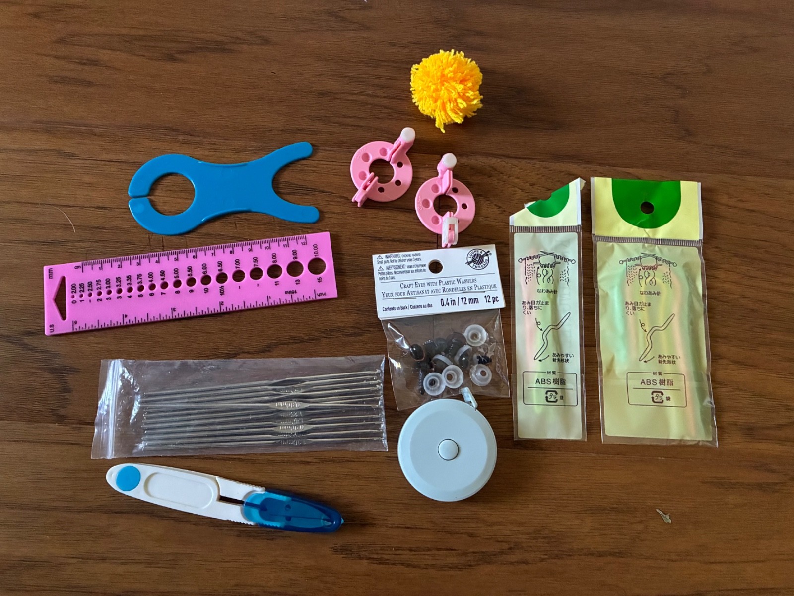 crochet hooks knitting needles yarn scissors craft eyes with washers tape measur
