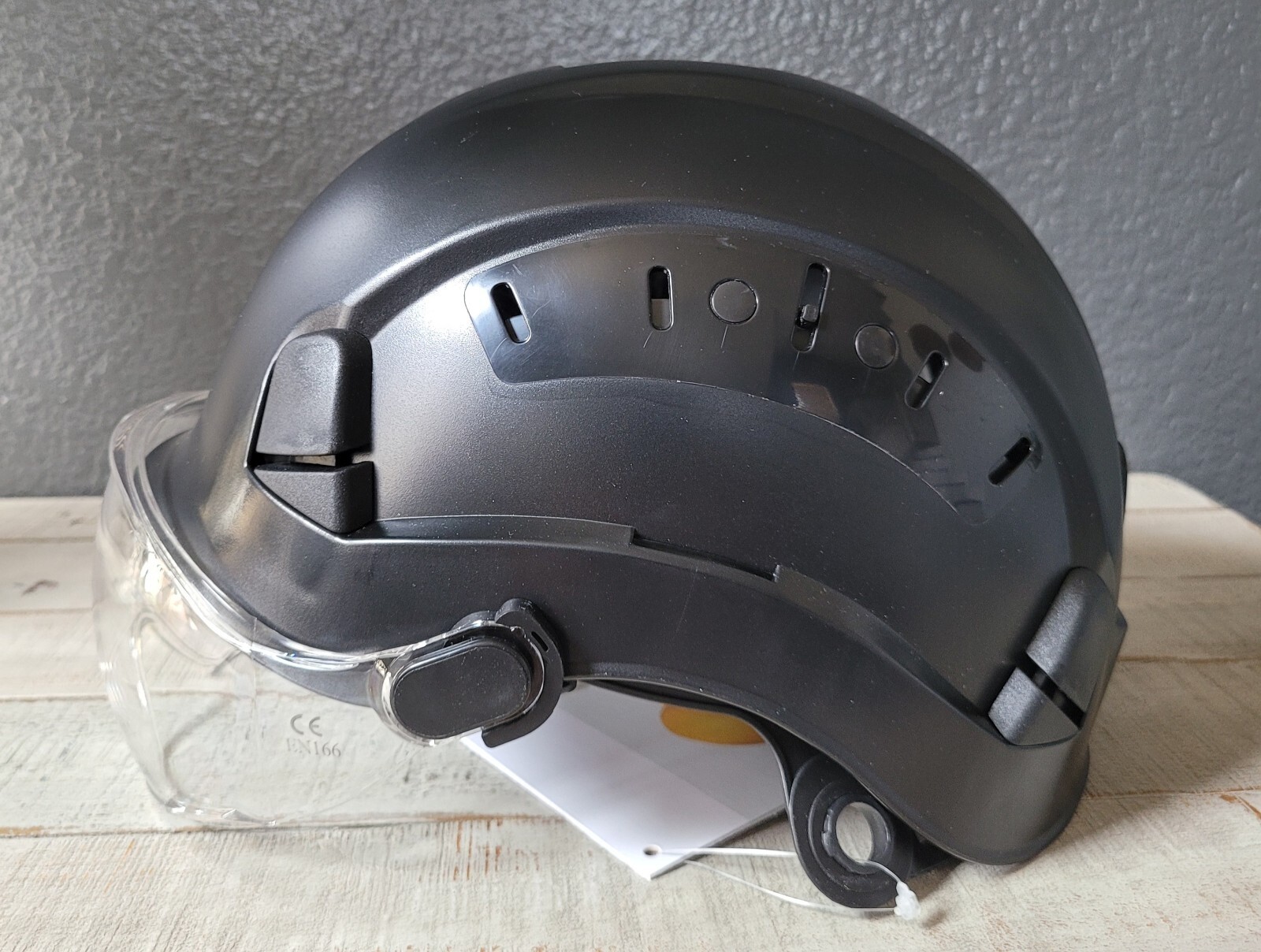 Arborist climber helmet with eye protection visor.