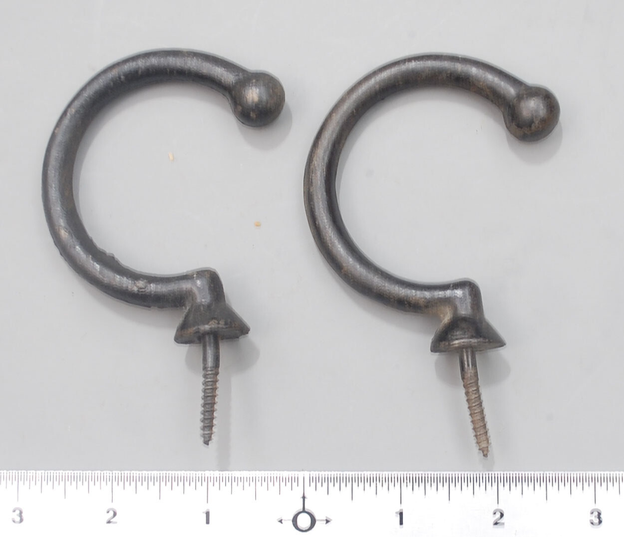 Two enameled under-rail bridge hooks