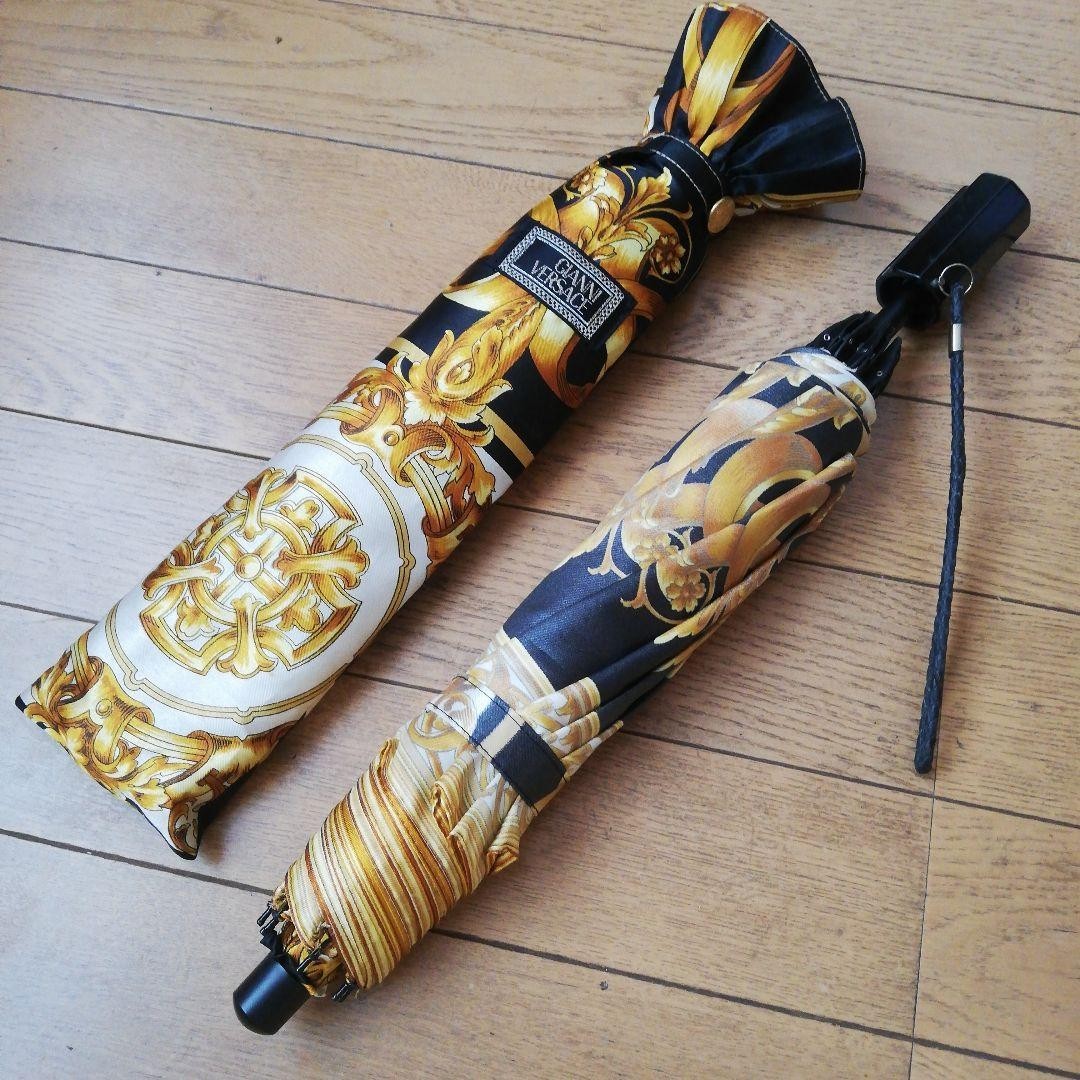 Excellent condition Gianni Versace folding umbrella; gold and black tones.