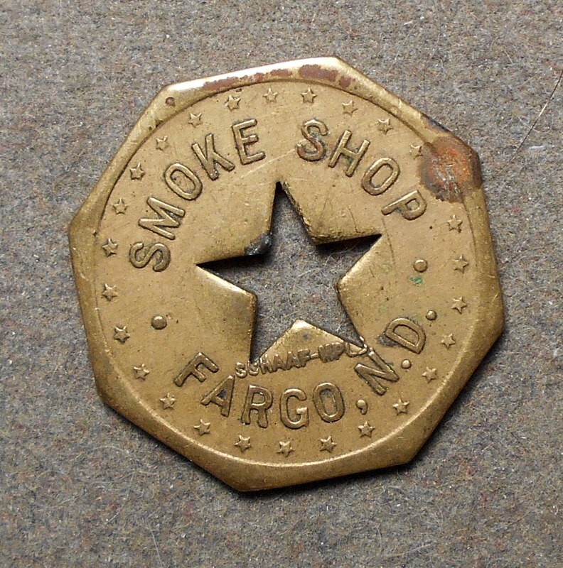 Fargo, N.D., Smoke Shop   Good For 5c – 5c In Trade. Brass, oct, star center ho