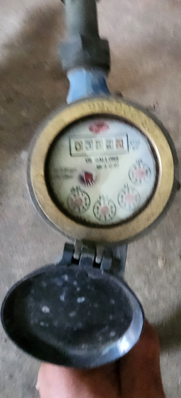 Badger Water Meter with Blue Housing, Protective Cover, and Pipe Fittings