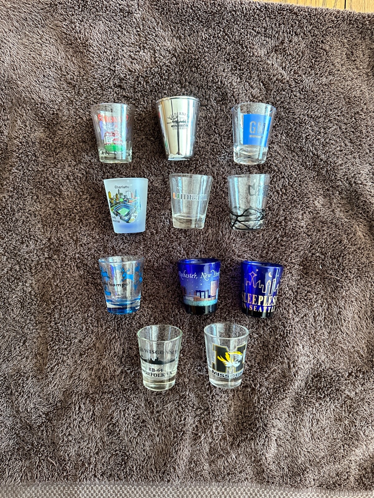 11 Collectable Themed Shot Glasses GM Colorado U of Miami Missouri Seattle Chi.