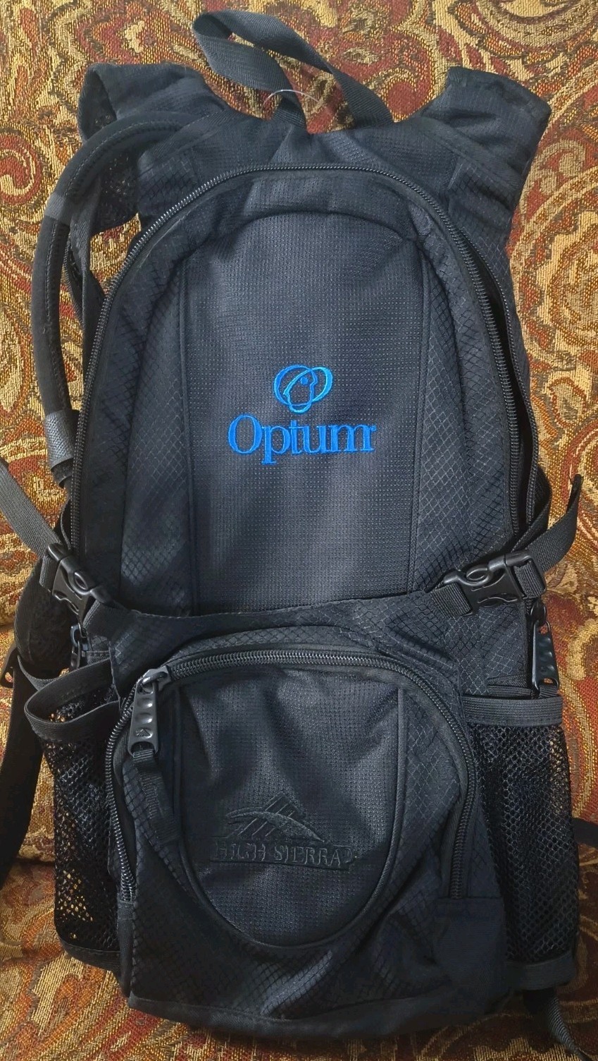 High Sierra lightweight hiking hydration pack customized with a blue Optum Logo