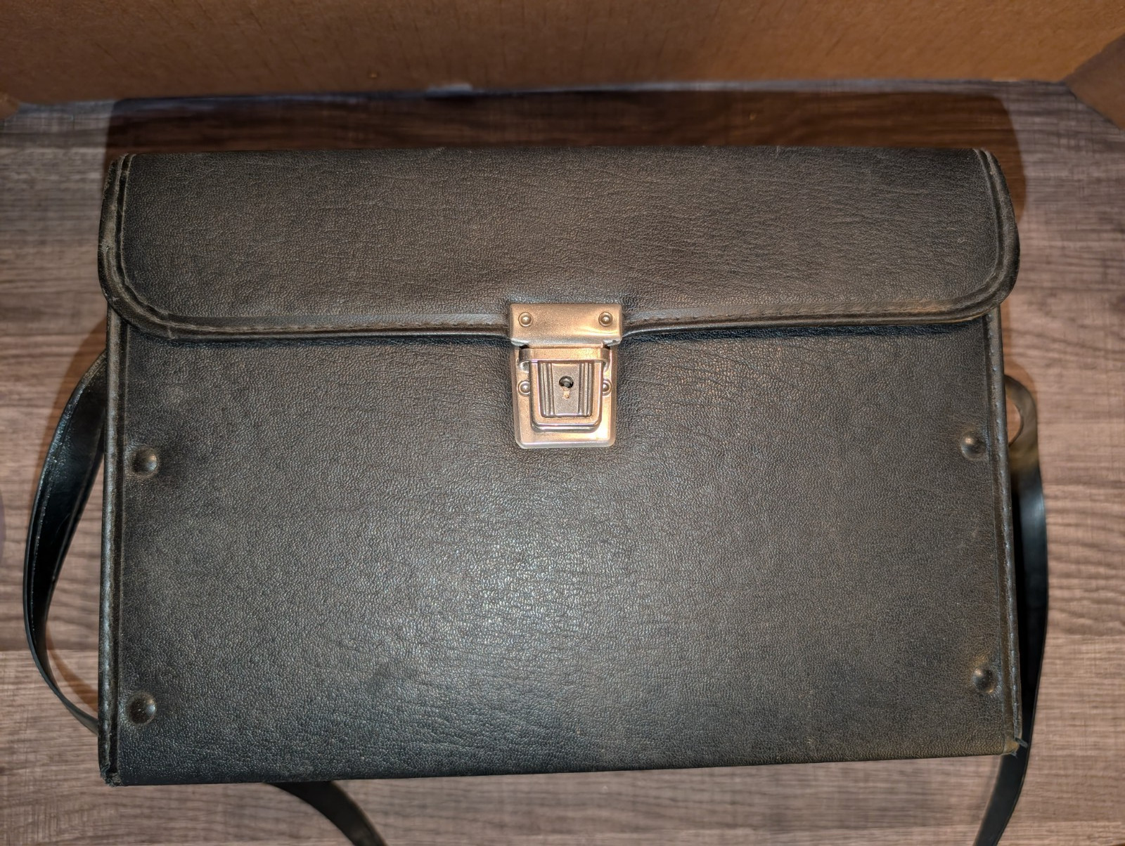 black hard-sided case with red interior dividers and shoulder strap (#242)