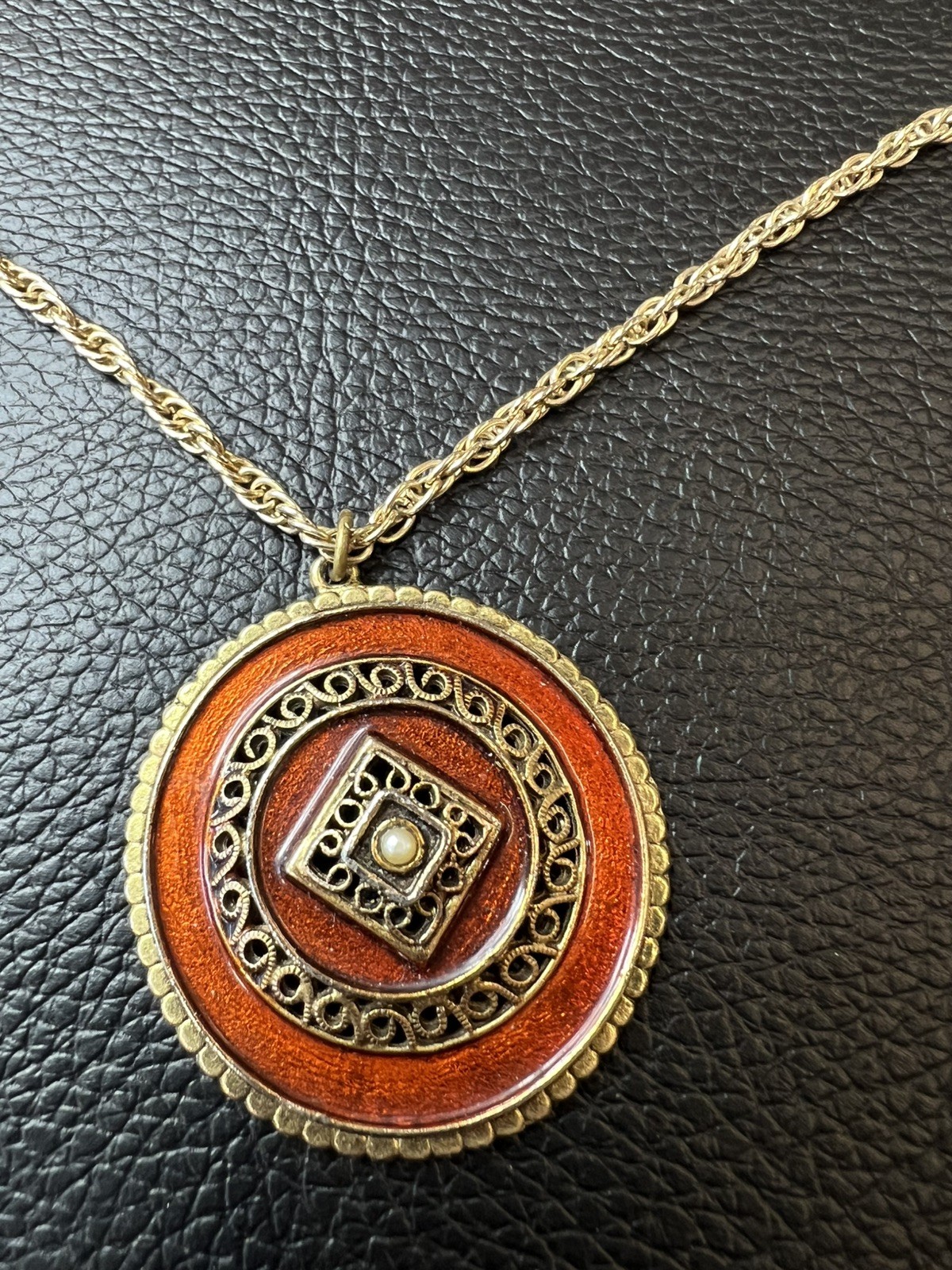 Vintage Gold plated round Aztec medallion with filigree and amber stone