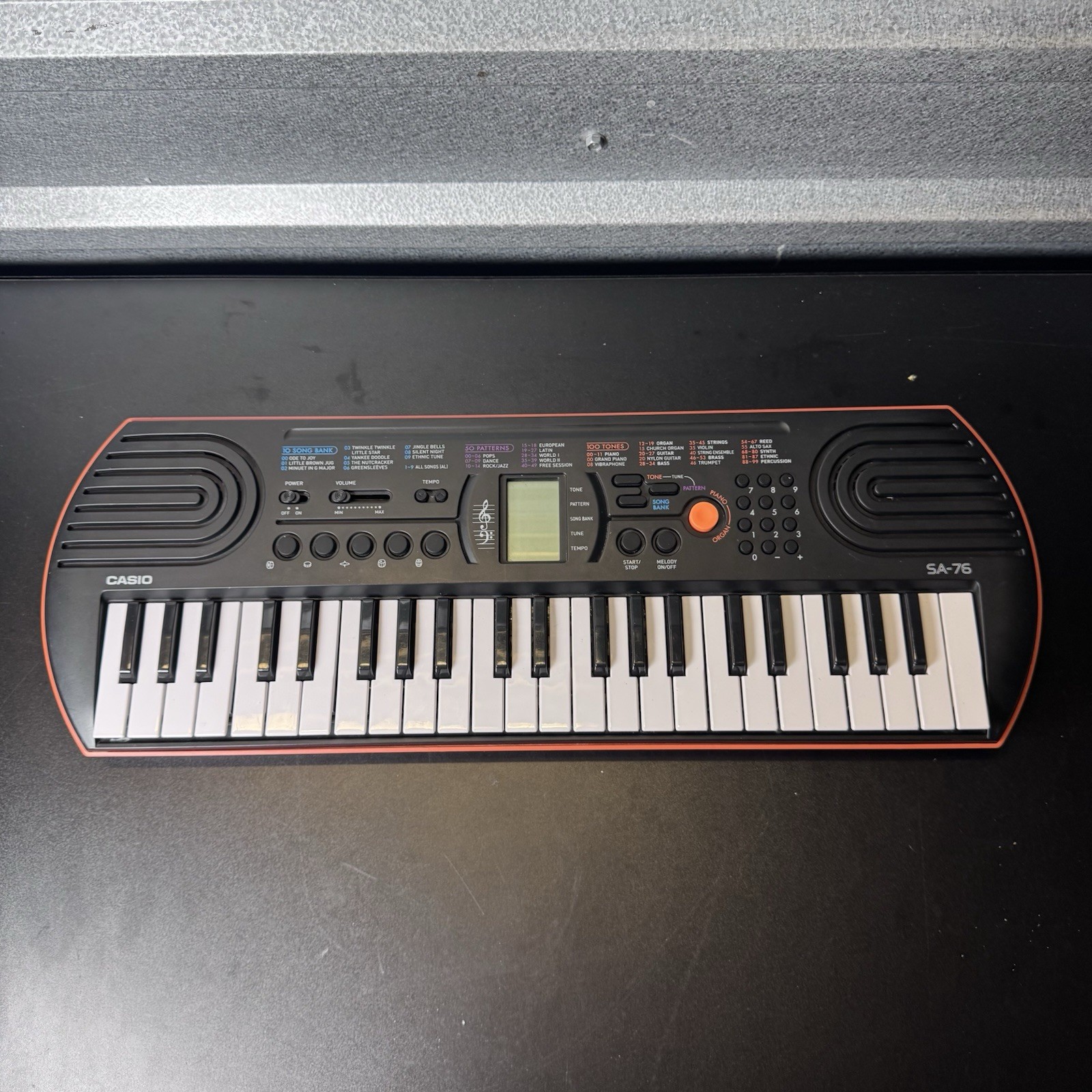 CASIO SA-76 44-Key Mini Electronic Keyboard 100 Tones 50 Rhythms Orange/Black