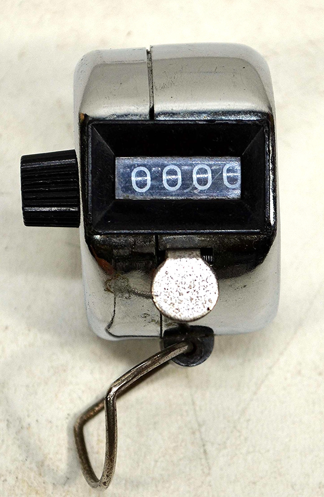 Vintage metal hand counter mechanism registers from 0 to 9999 with clicker lever