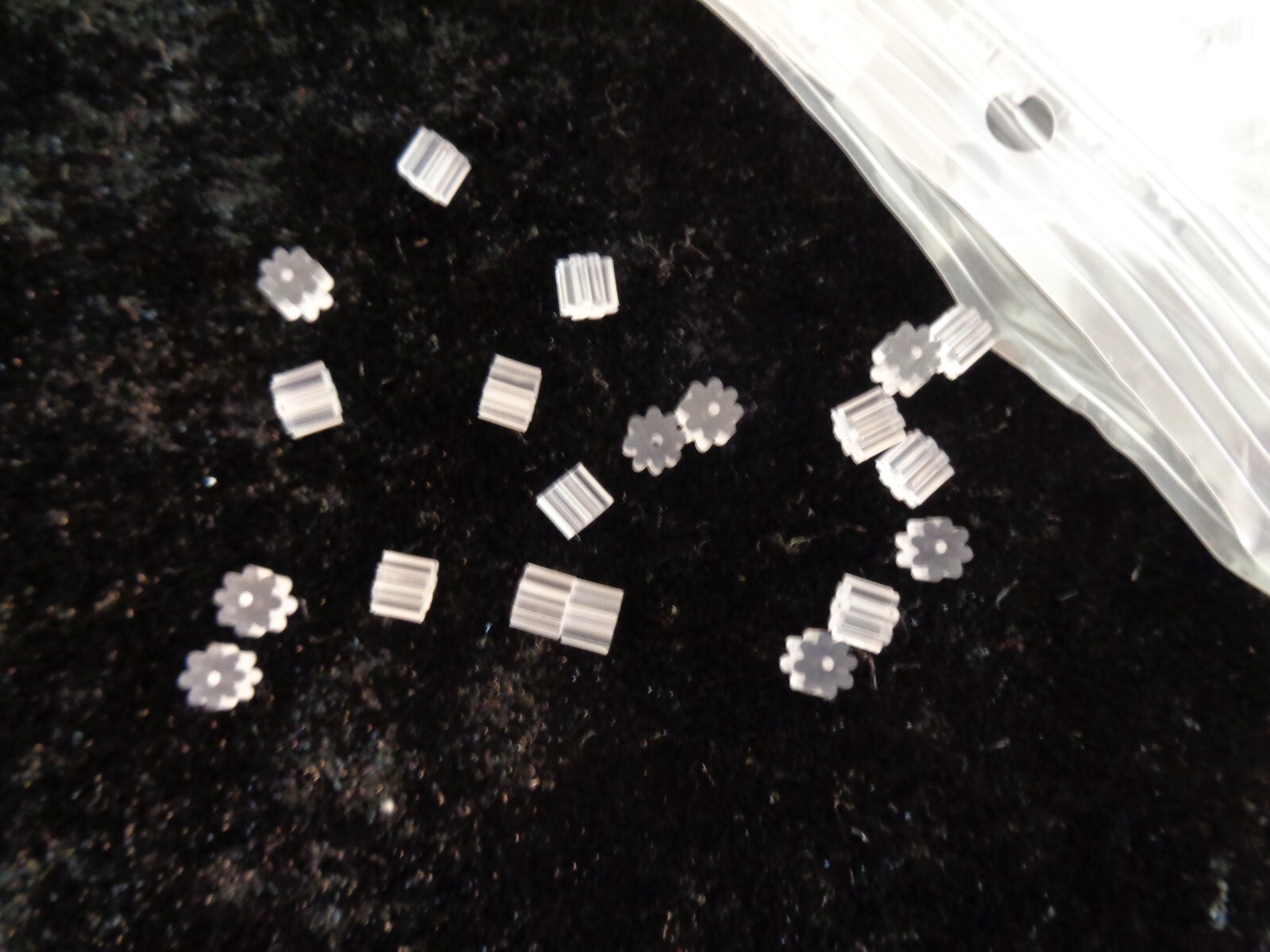 Earnut, plastic, clear, 4x3mm ribbed safety nut. Sold per pkg of 50 pairs.