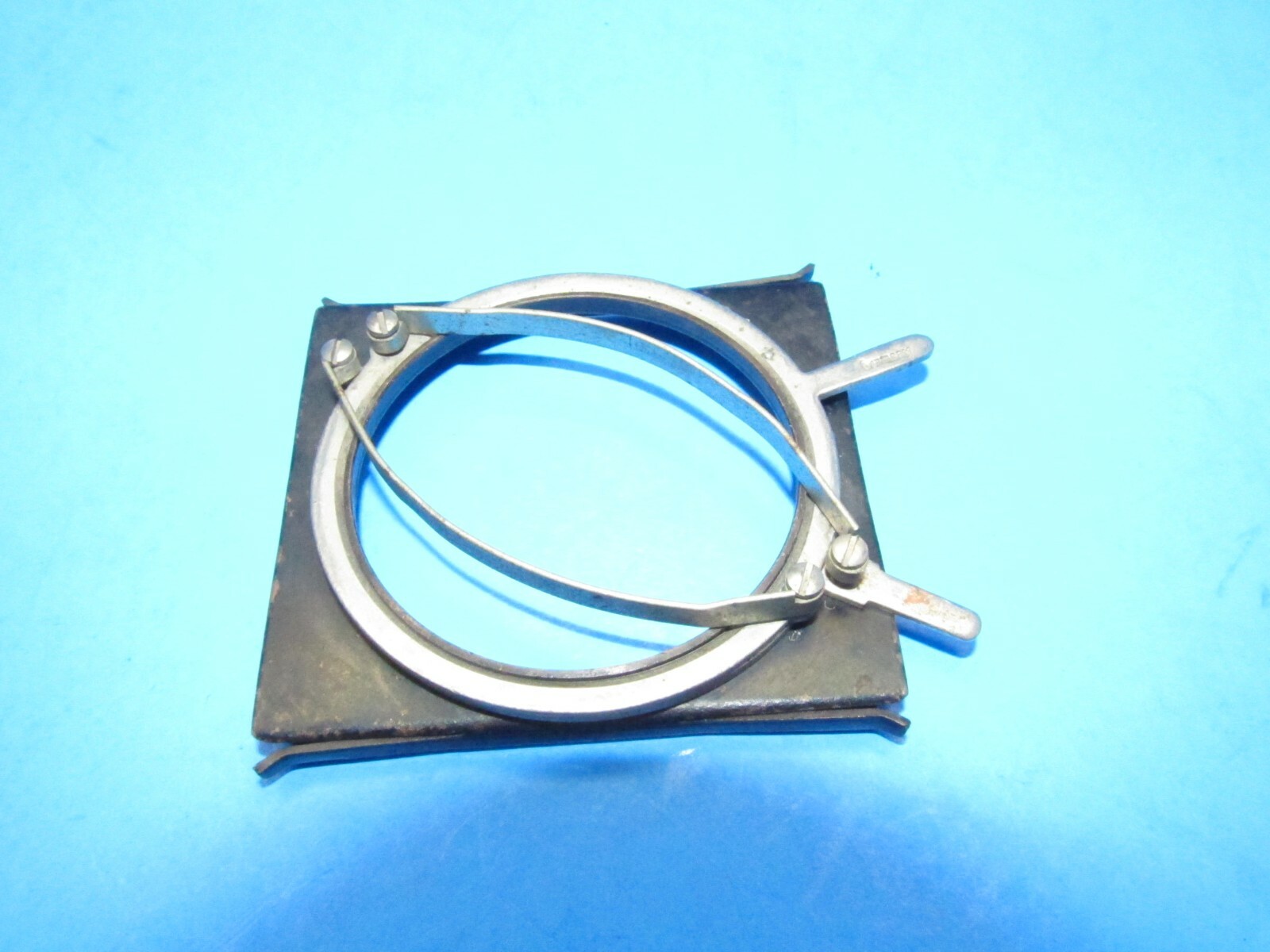 unique small filter holder marked RHACO DRP GERMANY attaches w/ spring clamps