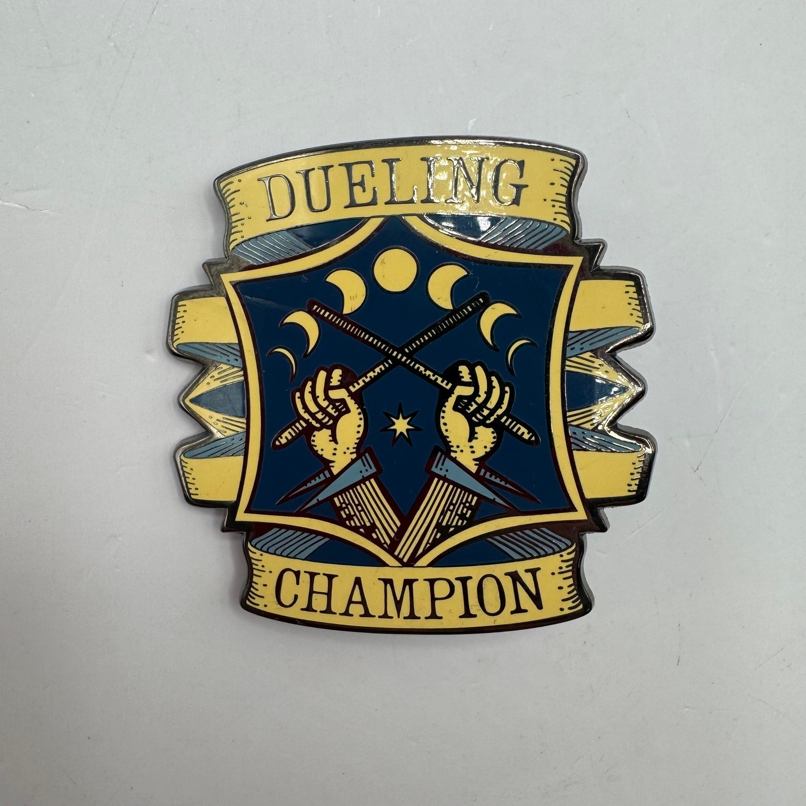 The Wizarding Trunk Dueling Champion Pin Blue Yellow Magic Wand Enamel