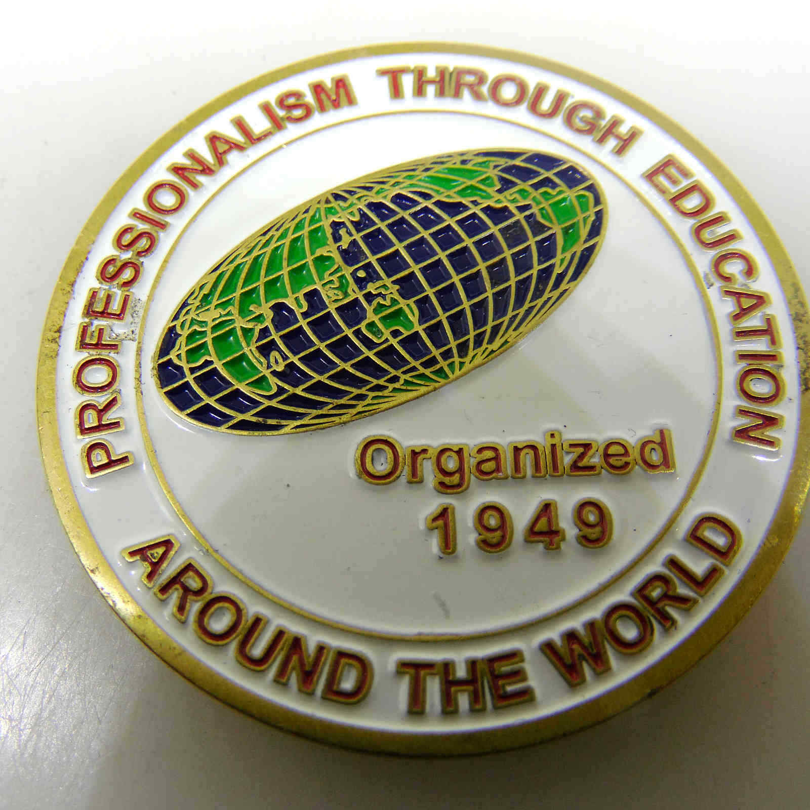 AROUND THE WORLD PROFESSIONALISM THROUGH EDUCATION CHALLENGE COIN