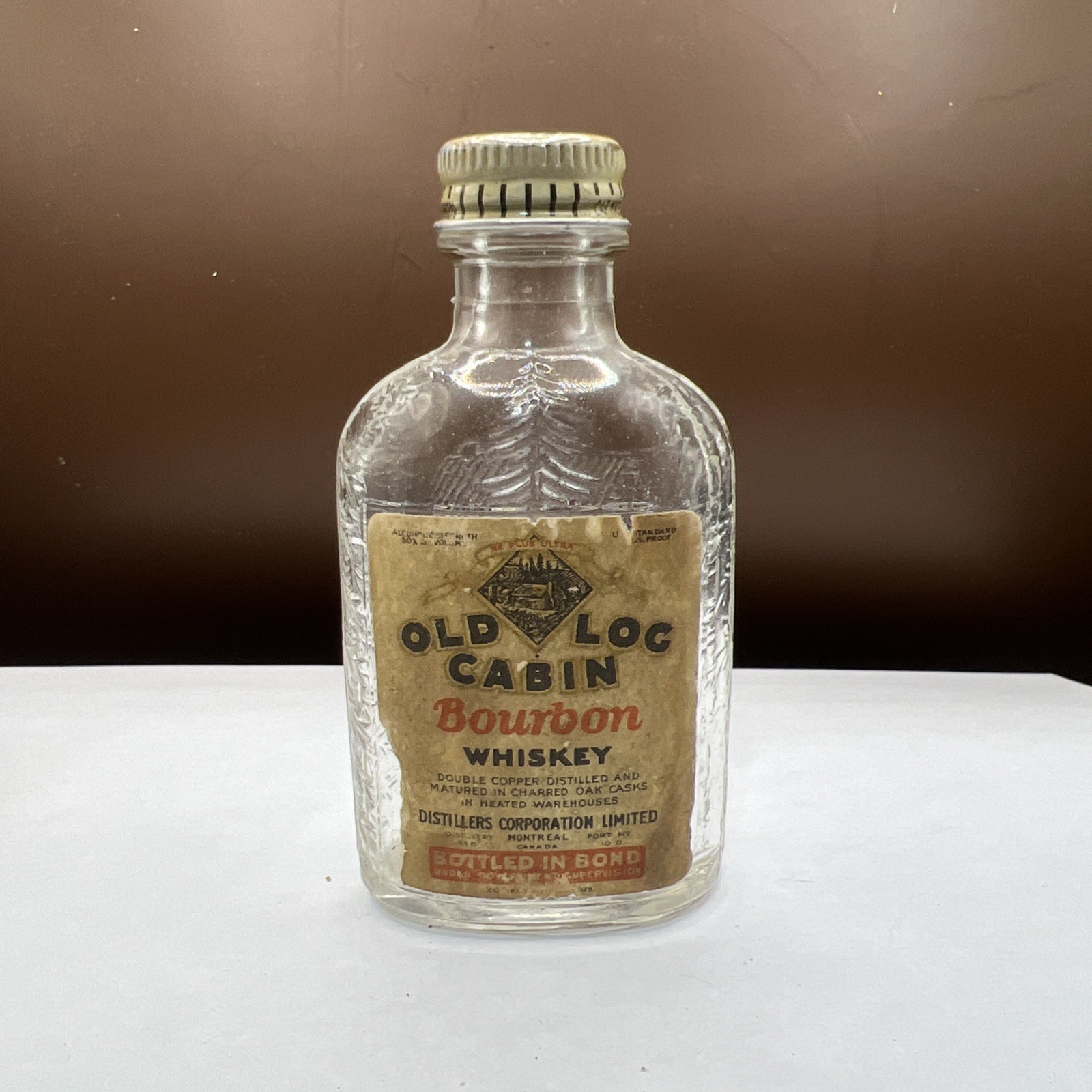 Vintage 2 oz. Glass bottle OLD LOG CABIN has paper label, cap