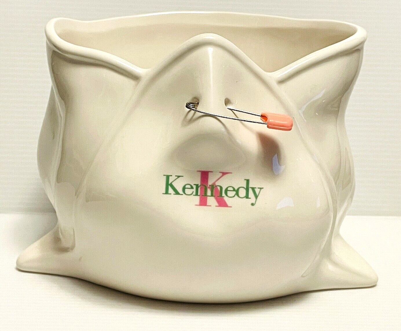 Babychix ceramic diaper shaped planter with safety pin, says Kennedy on planter.