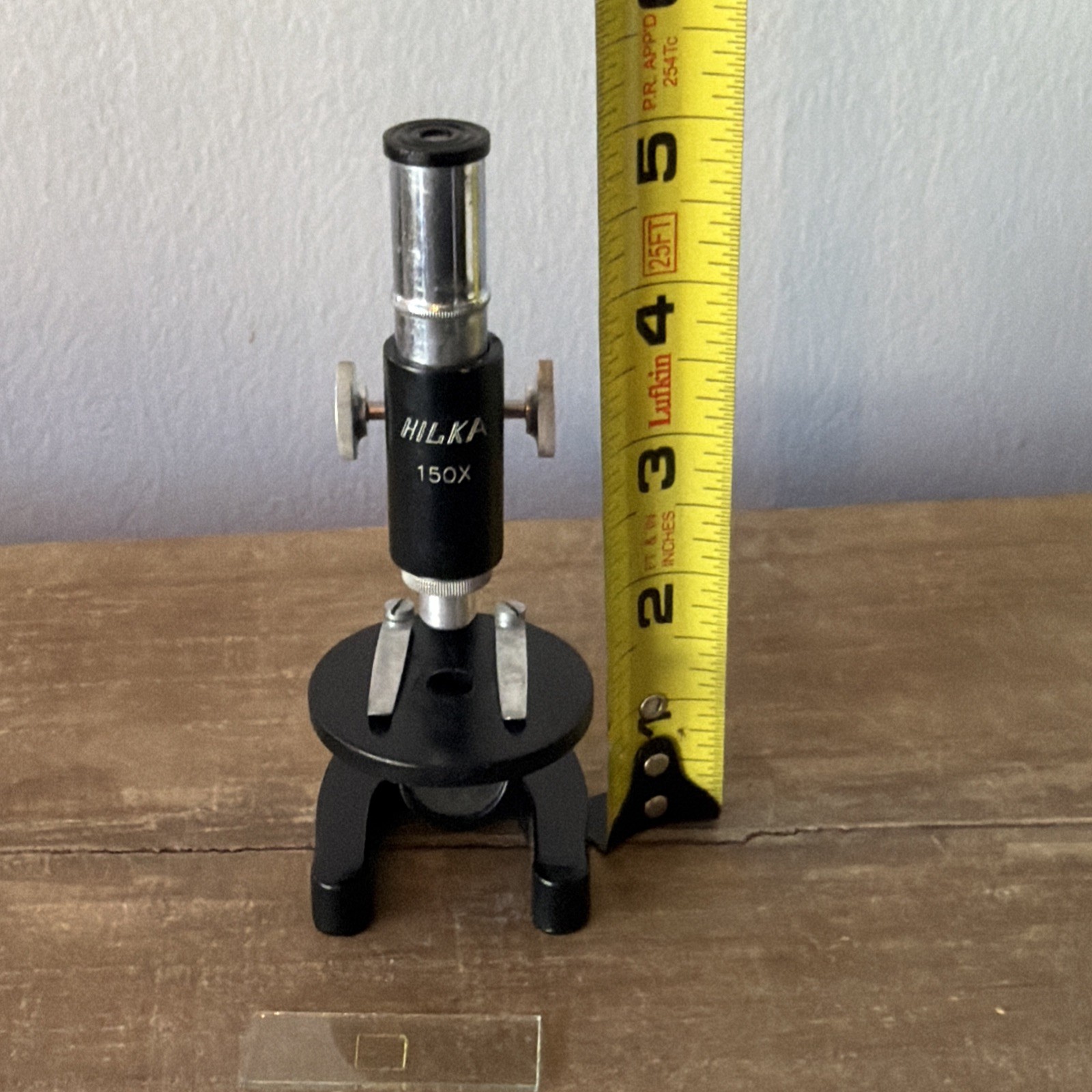 Vintage HIKA 150x Microscope 5in. Includes 3 slides and original box.