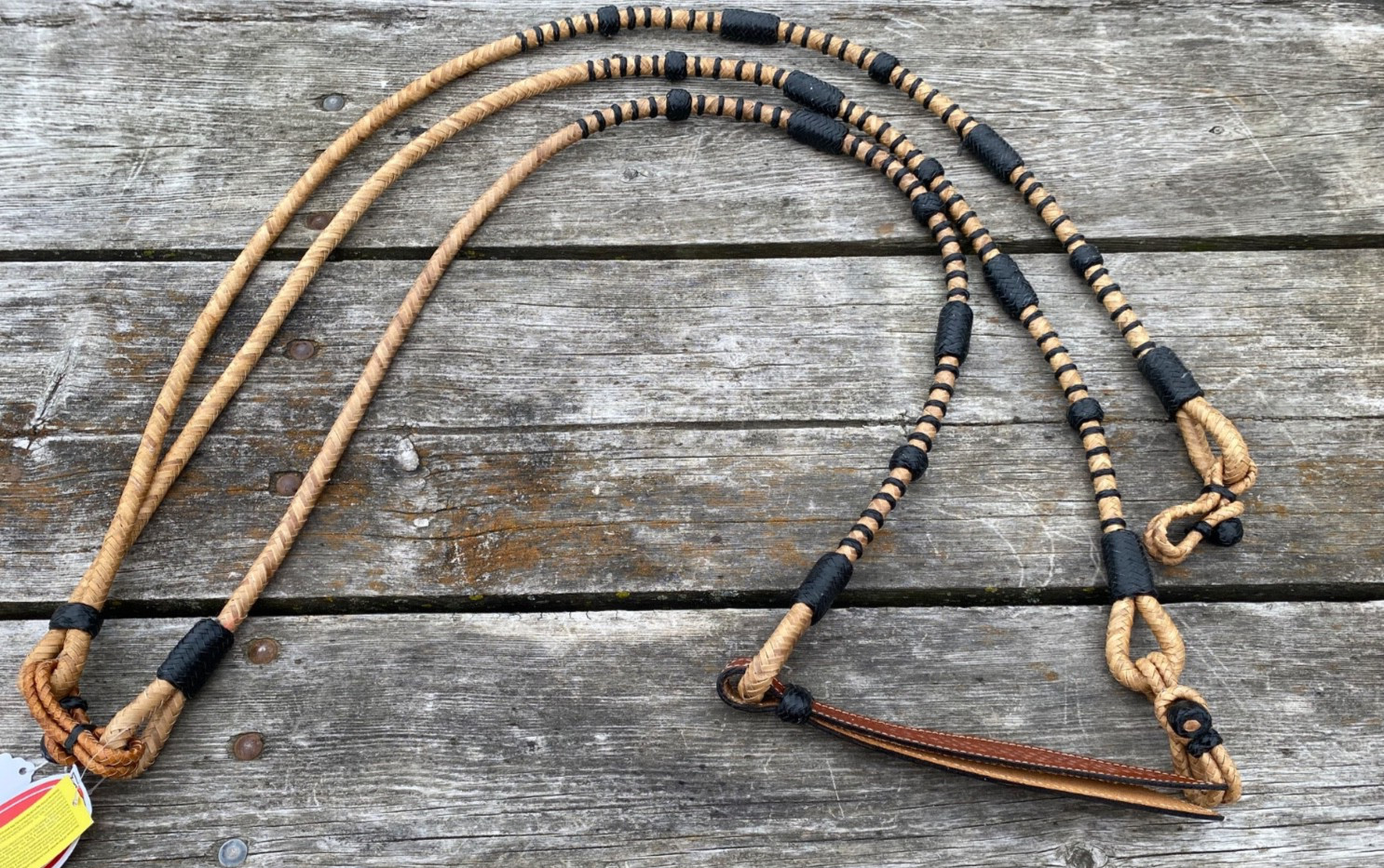 Braided rawhide Romel/Romal reins w/black accents & leather popper