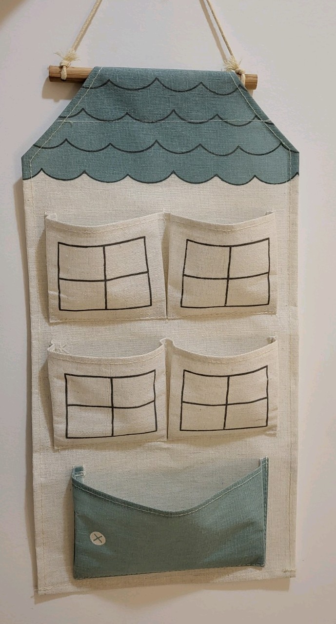 Fabric house-shaped wall pocket or hanging organizer.