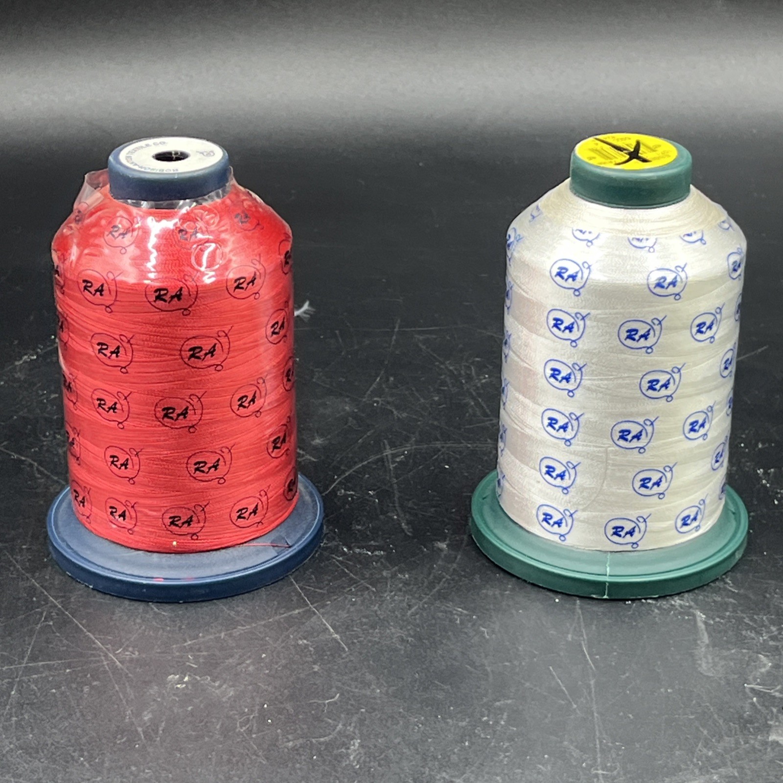 Embroidery machine thread spools red and white