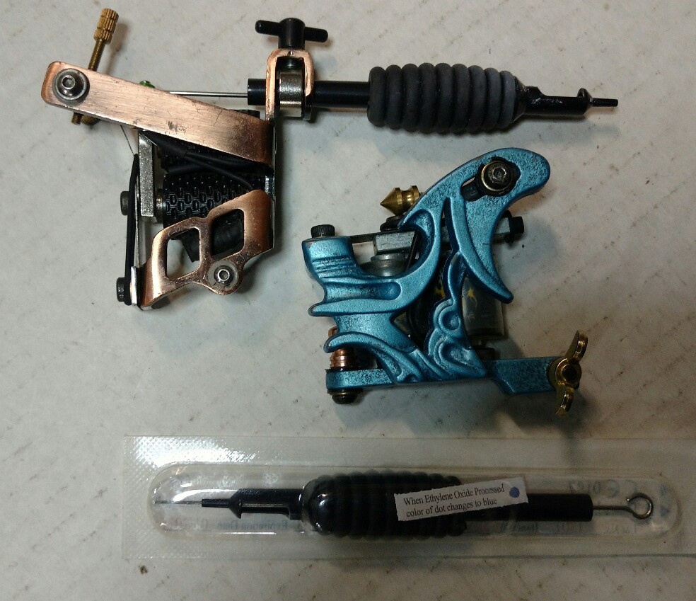 A pair of tattoo guns and case