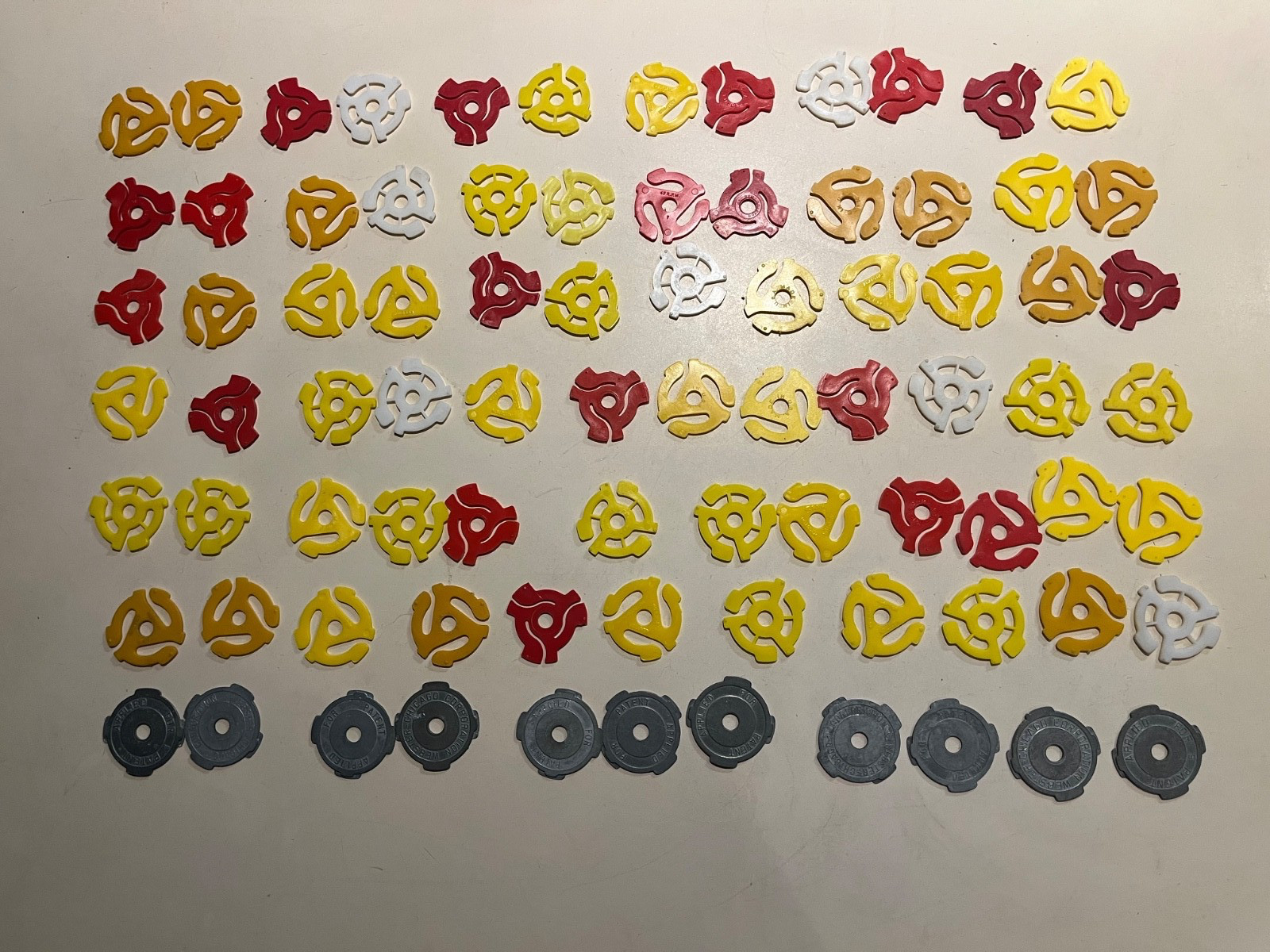 Lot of 84 vintage 45 RPM spindle adapters – metal and plastic – retro records