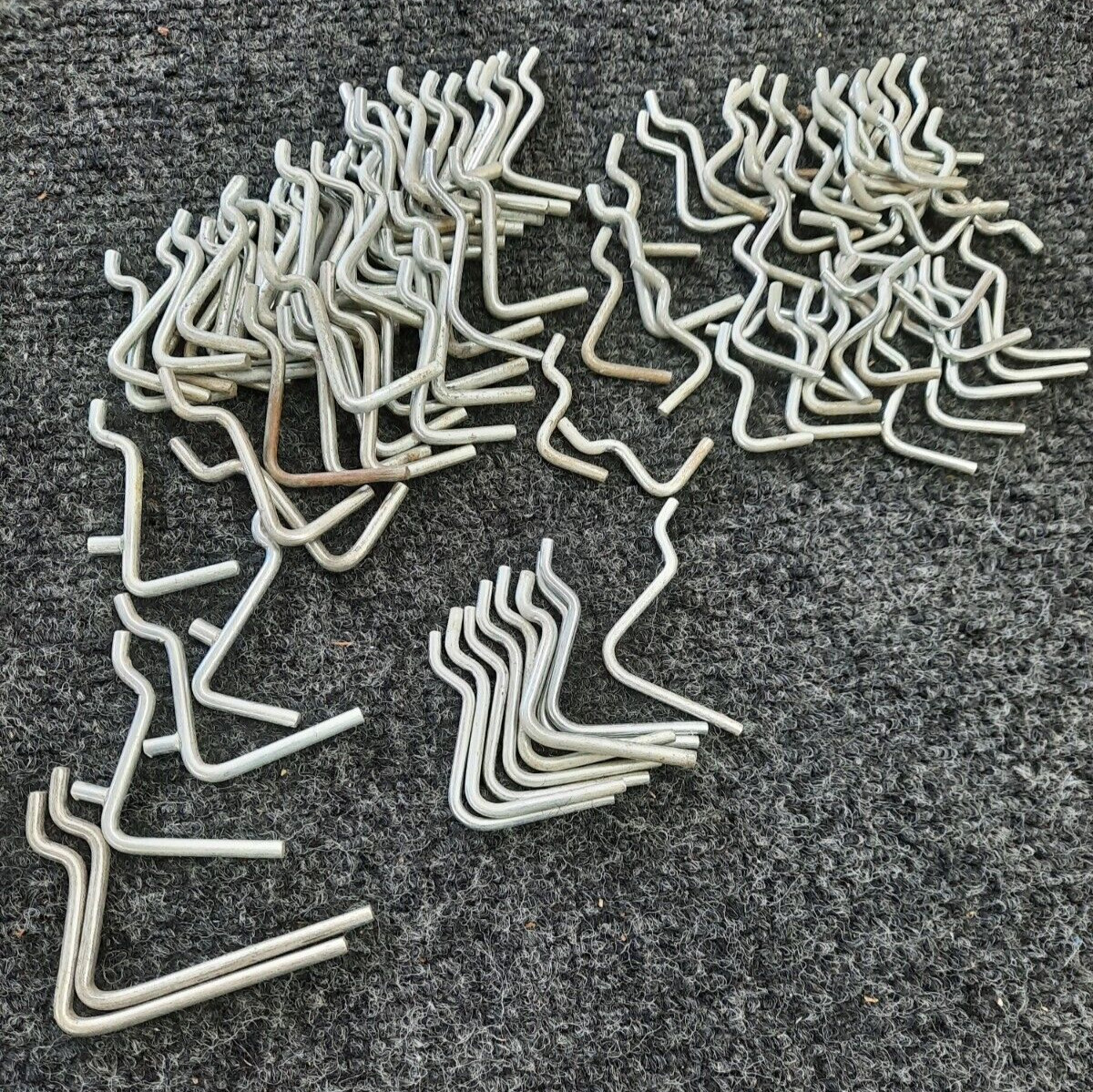 100 used assorted V shaped pegboard hooks