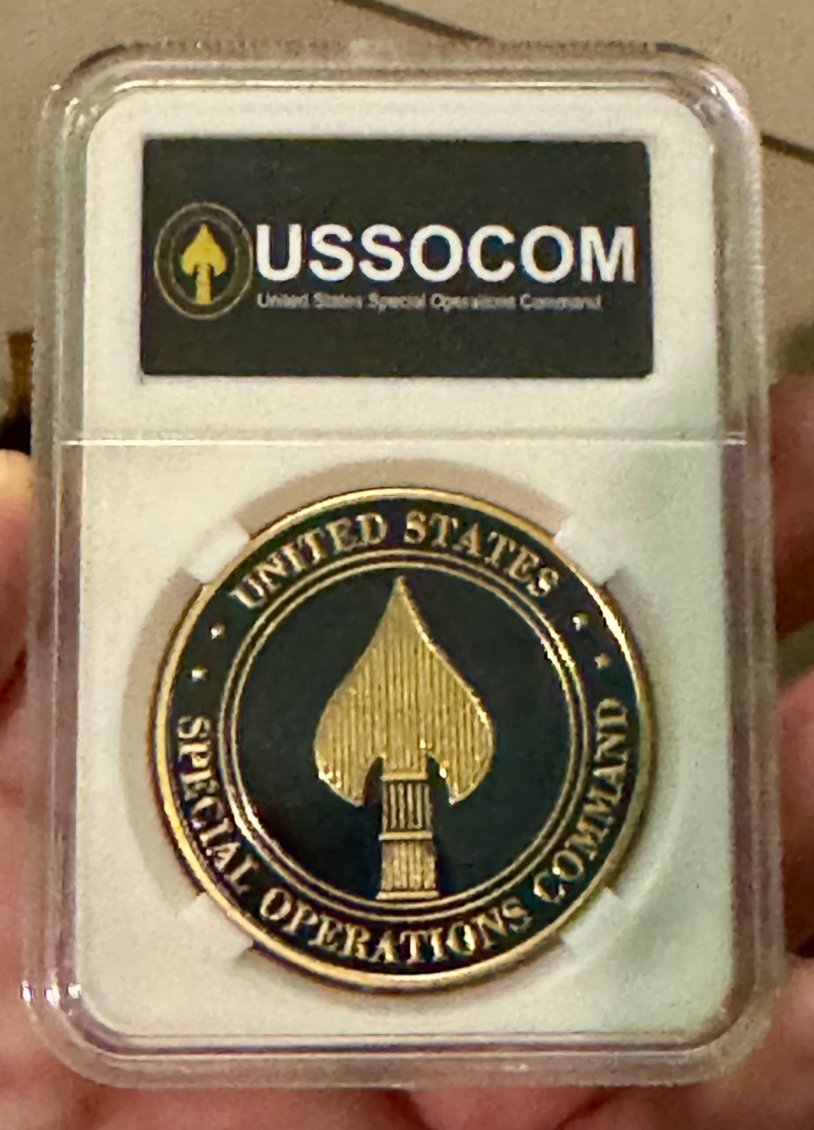 United States Special Operations Command Challenge coin in display case