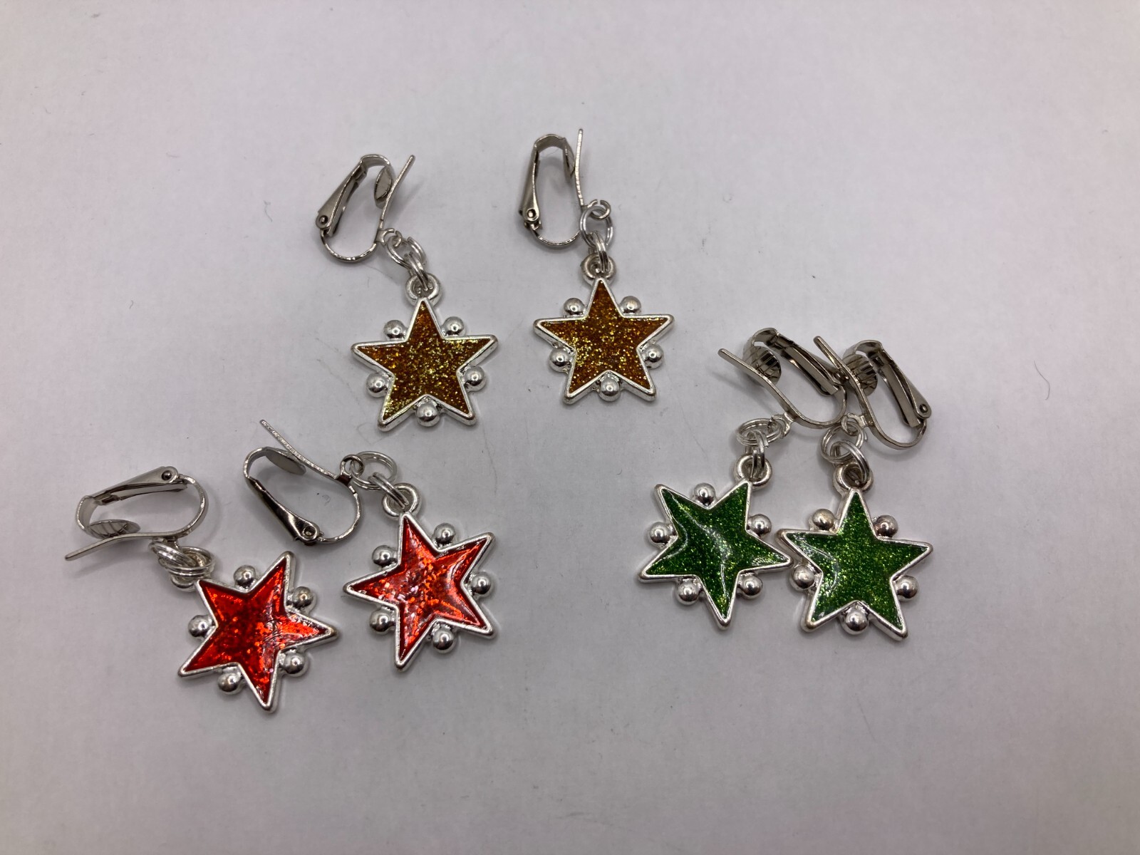 Lot of 3 Pairs Shimmering Stars Clip-On Silvertone Earrings in Red, Green & Gold