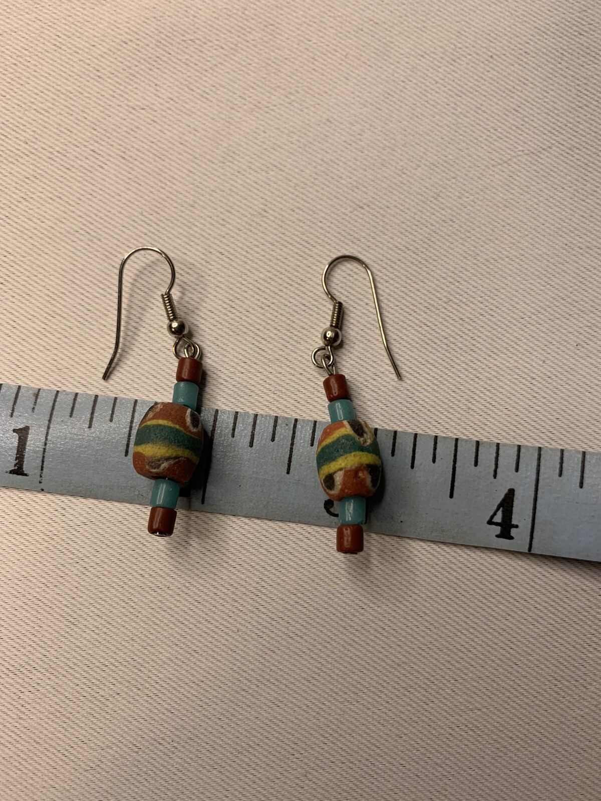 Silvertone and painted wood pierced earrings
