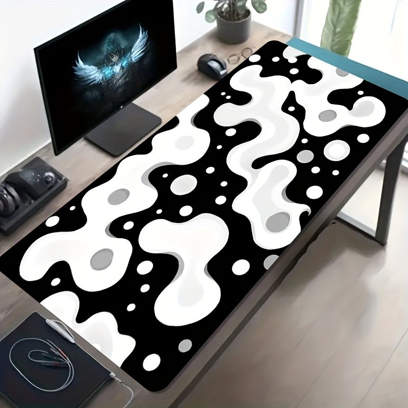 A Large Gaming Mouse Pad Featuring a Black And White Fluid Polka Dot Abstract A